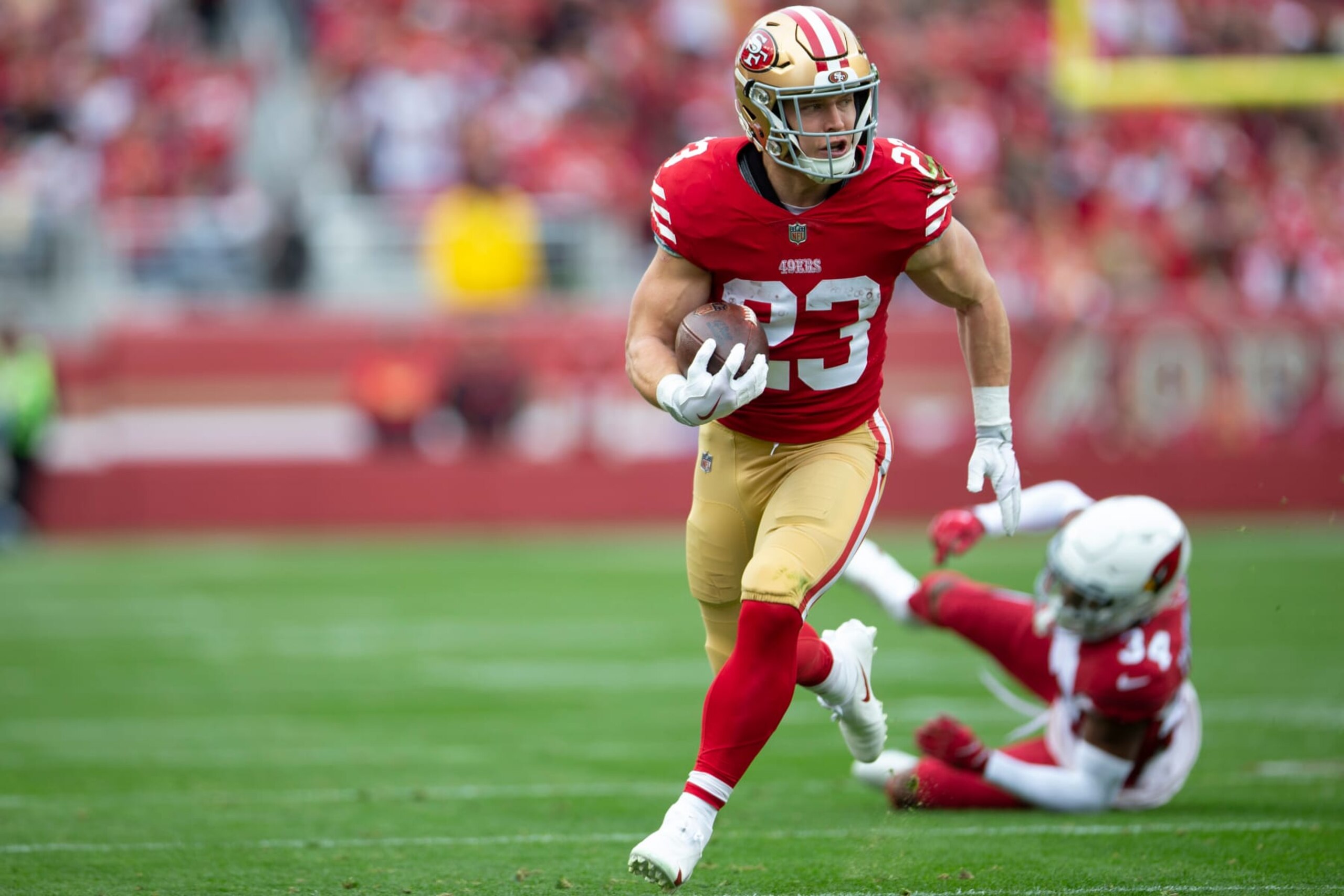 SANTA CLARA, CA - JANUARY 8: Christian McCaffrey #23 of the San Francisco 49ers runs after making a catch for a 21-yard touchdown during the game against the Arizona Cardinals at Levi's Stadium on January 8, 2023 in Santa Clara, California. The 49ers defeated the Cardinals 38-13. (Photo by Michael Zagaris/San Francisco 49ers/Getty Images)