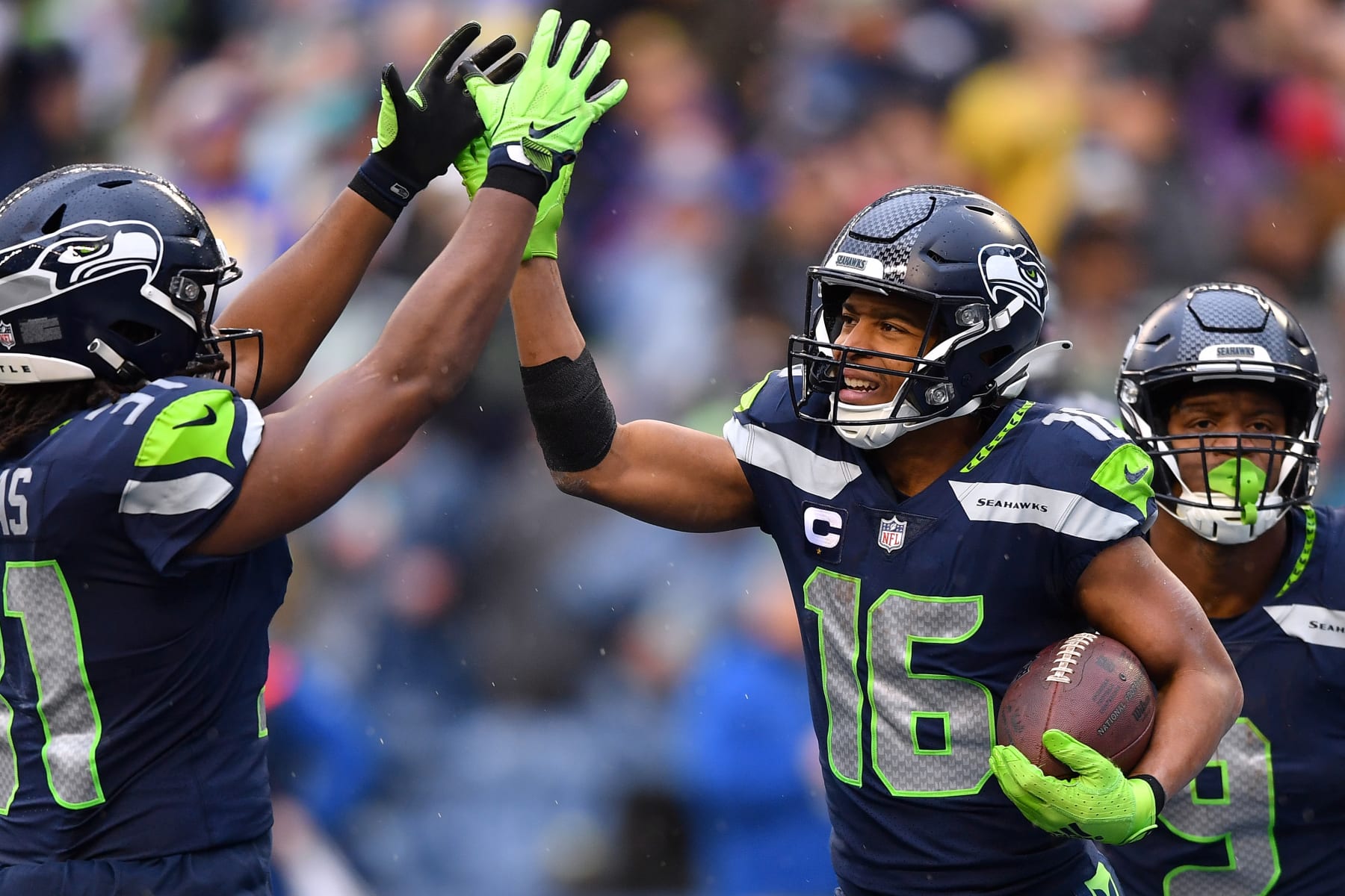 SEATTLE, WASHINGTON - JANUARY 08: Tyler Lockett #16 of the Seattle Seahawks celebrates with DeeJay Dallas #31 of the Seattle Seahawks after catching a pass for a touchdown during the third quarter against the Los Angeles Rams at Lumen Field on January 08, 2023 in Seattle, Washington. (Photo by Jane Gershovich/Getty Images)