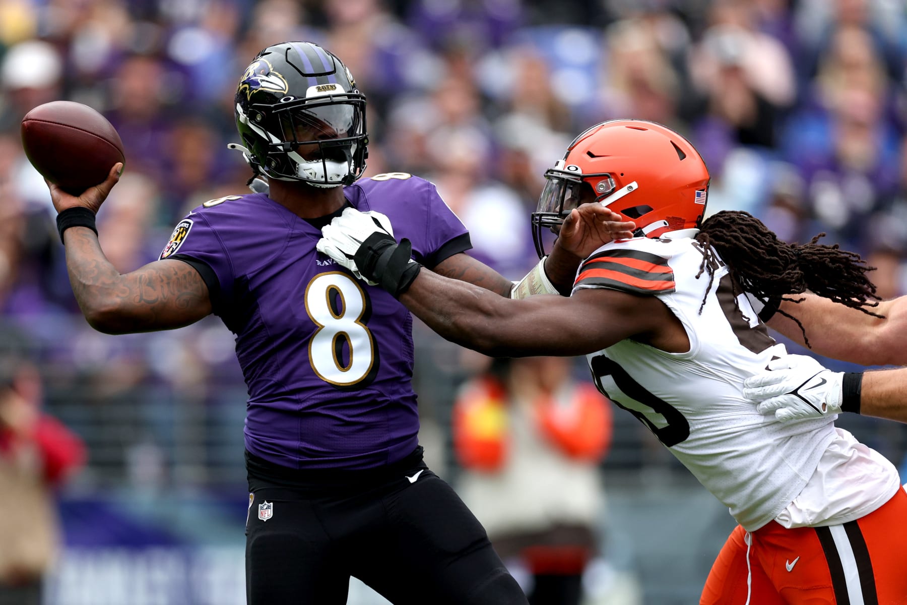 BALTIMORE, MARYLAND - OCTOBER 23: Lamar Jackson #8 of the Baltimore Ravens throws the ball while being pressured by Jadeveon Clowney #90 of the Cleveland Browns during the first quarter of the game at M&T Bank Stadium on October 23, 2022 in Baltimore, Maryland. (Photo by Rob Carr/Getty Images)
