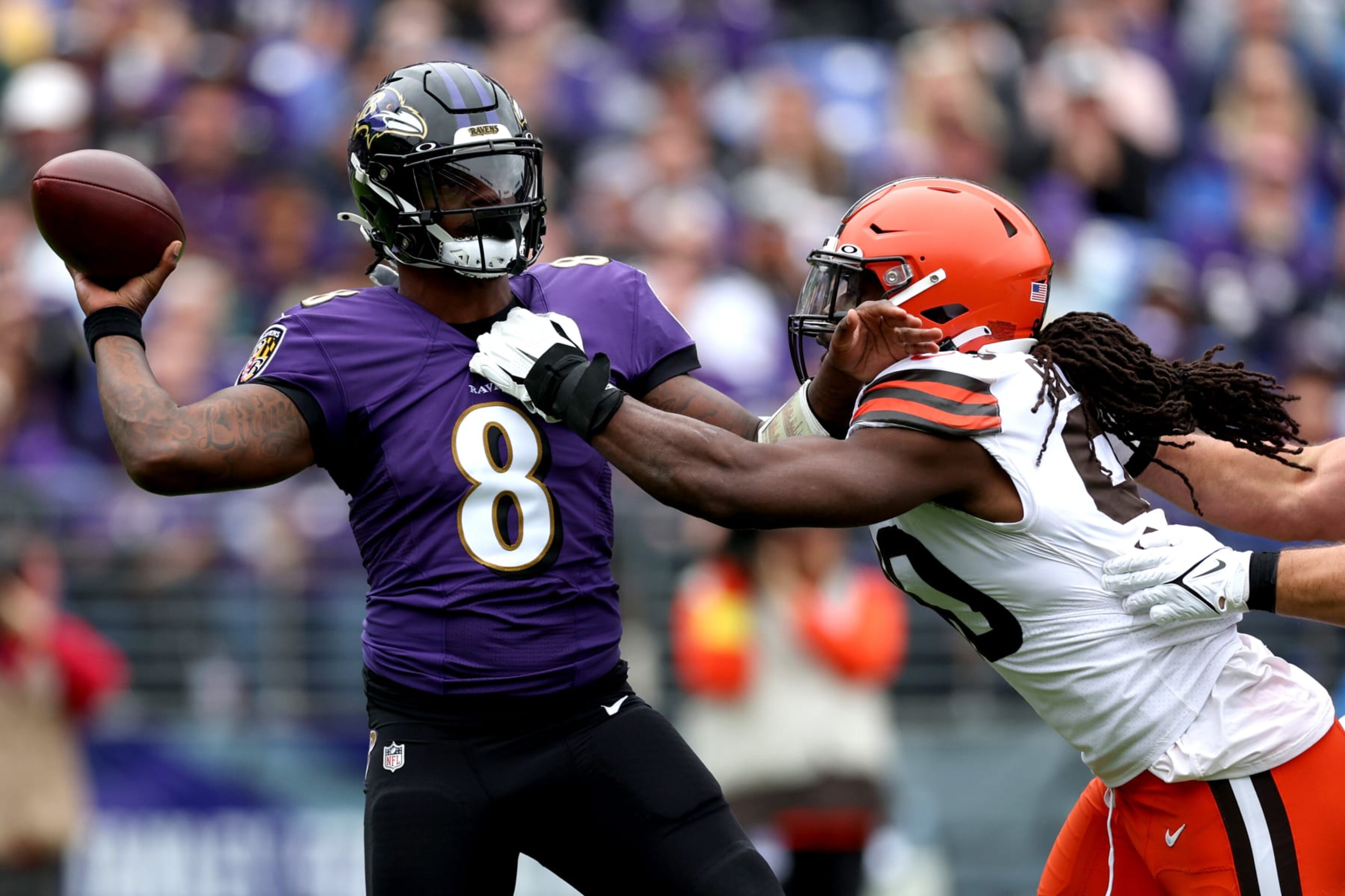 BALTIMORE, MARYLAND - OCTOBER 23: Lamar Jackson #8 of the Baltimore Ravens throws the ball while being pressured by Jadeveon Clowney #90 of the Cleveland Browns during the first quarter of the game at M&T Bank Stadium on October 23, 2022 in Baltimore, Maryland. (Photo by Rob Carr/Getty Images)
