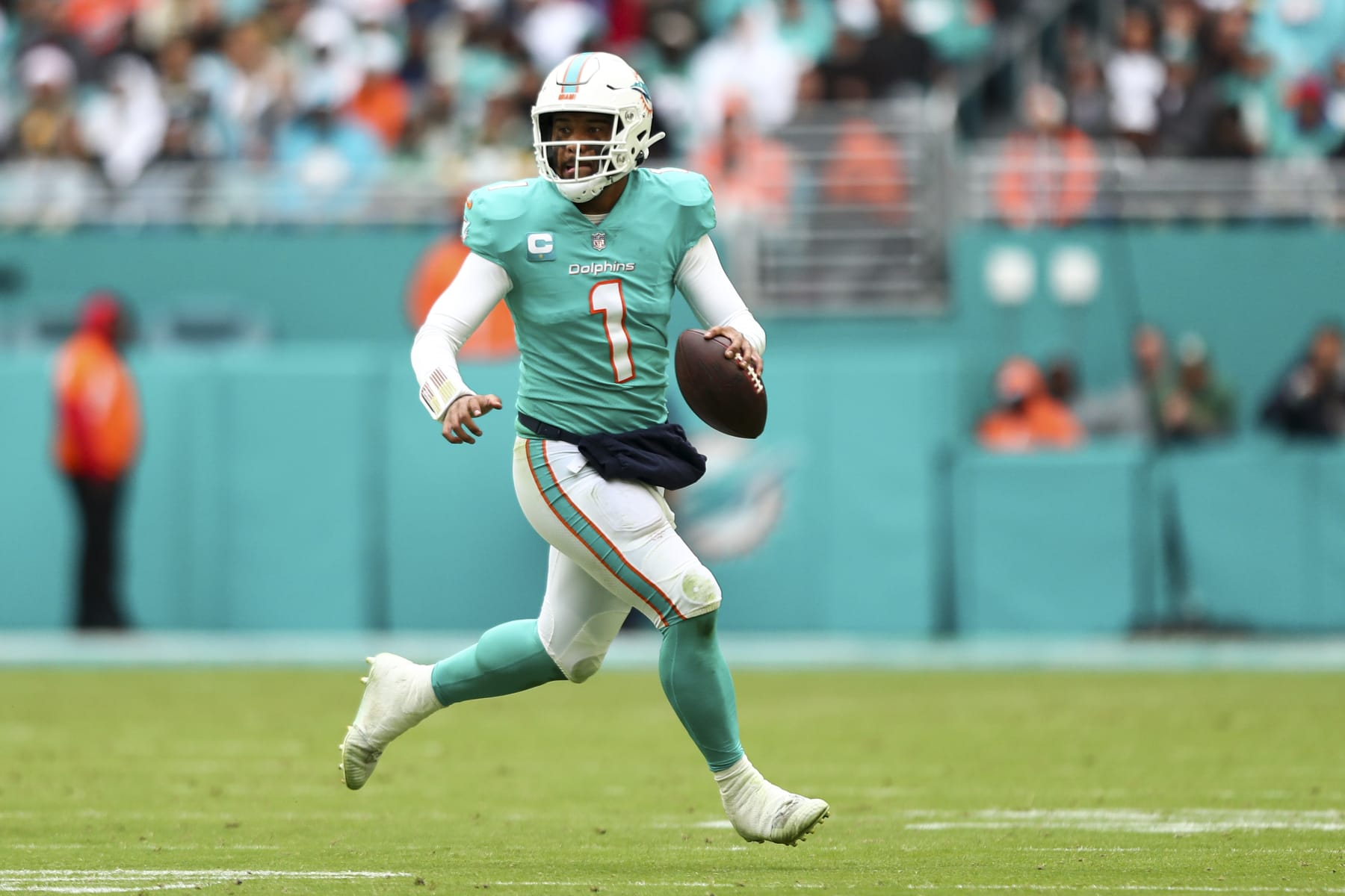 MIAMI GARDENS, FL - DECEMBER 25: Tua Tagovailoa #1 of the Miami Dolphins scrambles out of the pocket during the third quarter of an NFL football game against the Green Bay Packers at Hard Rock Stadium on December 25, 2022 in Miami Gardens, Florida. (Photo by Kevin Sabitus/Getty Images)