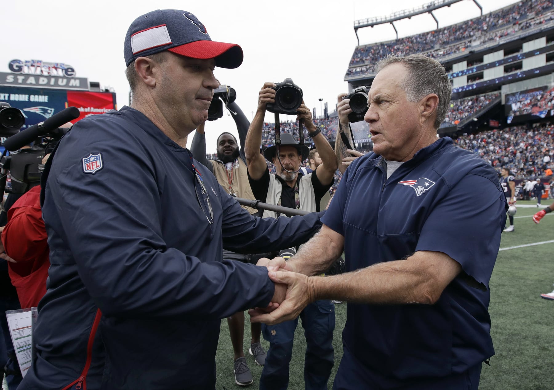 Houston Texans head coach Bill O'Brien, left, and New England Patriots head coach Bill Belichick speak at midfield after an NFL football game, Sunday, Sept. 9, 2018, in Foxborough, Mass. (AP Photo/Charles Krupa)