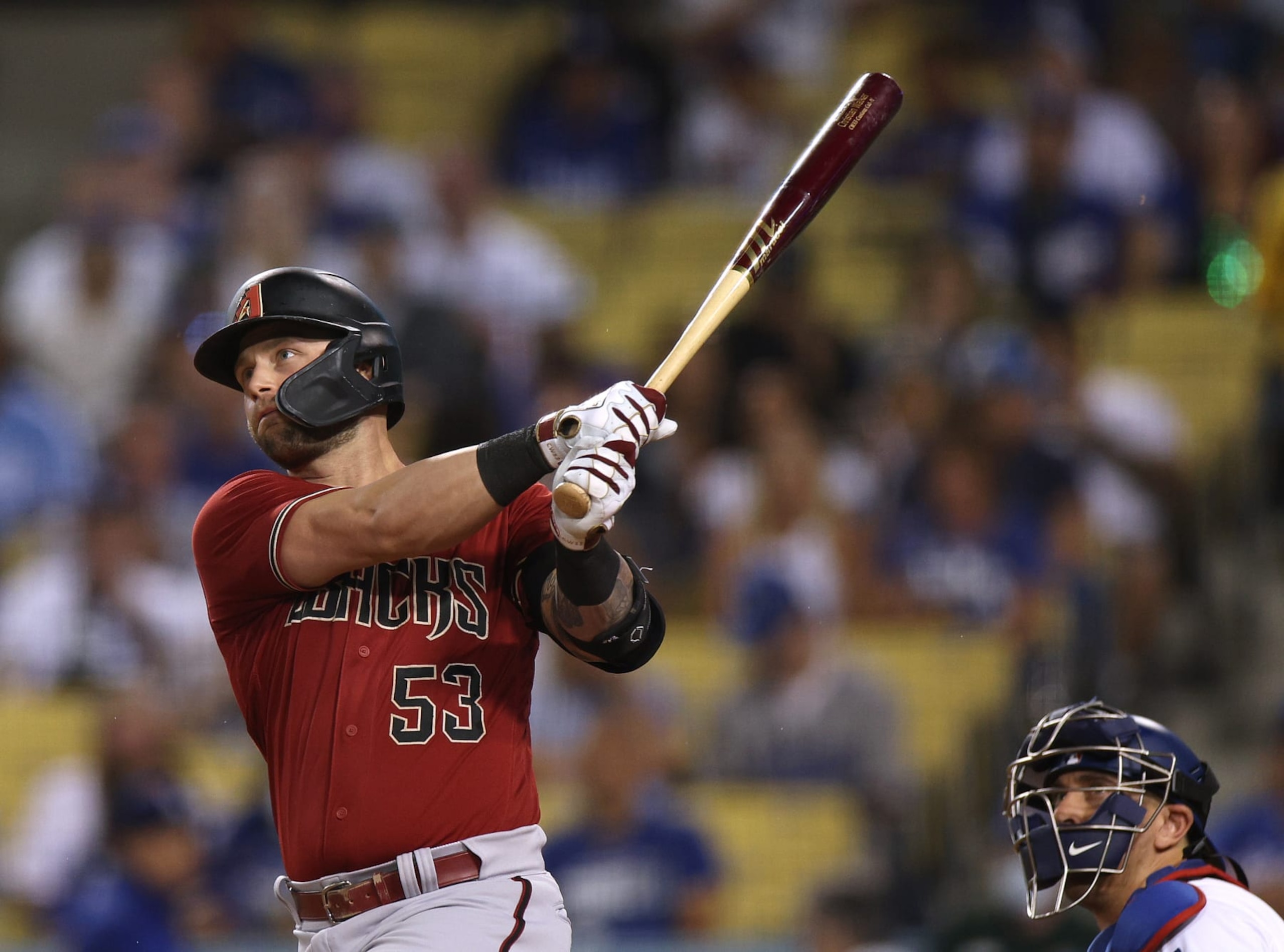 LOS ANGELES, CALIFORNIA - SEPTEMBER 21: Christian Walker #53 of the Arizona Diamondbacks hits an RBI single in front of Austin Barnes #15 of the Los Angeles Dodgers, to score Daulton Varsho #12  for a 1-0 lead, during the first inning at Dodger Stadium on September 21, 2022 in Los Angeles, California. (Photo by Harry How/Getty Images)