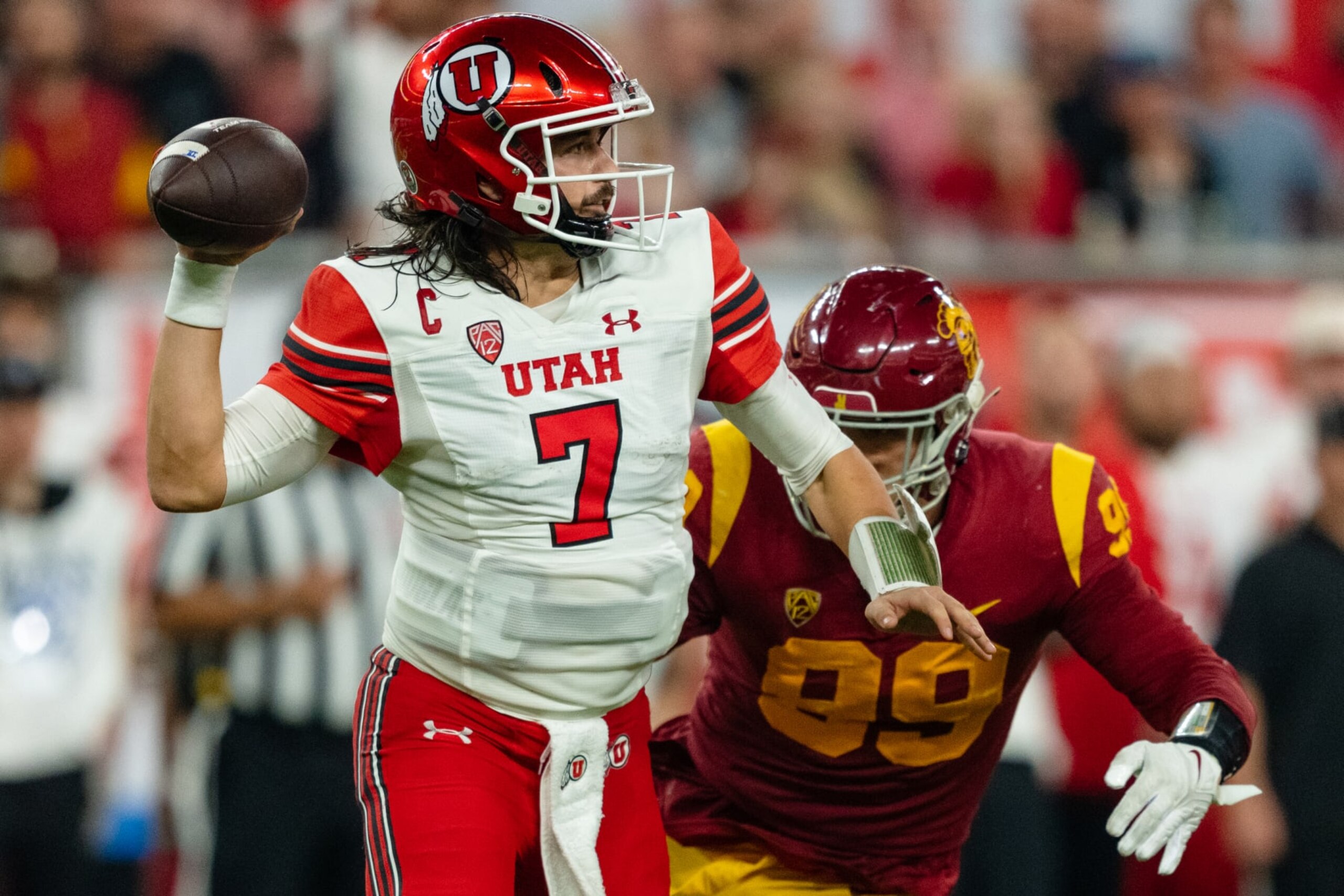 LAS VEGAS, NV - DECEMBER 2: Cameron Rising #7 of Utah throws a pass before being nearly sacked by Nick Figueroa #99 of USC during a game between the USC Trojans and the Utah Utes at Allegiant Stadium on December 2, 2022 in Las Vegas, Nevada. (Photo by Jason Allen/ISI Photos/Getty Images). LAS VEGAS, NV - DECEMBER 2: Cameron Rising #7 of Utah throws a pass before being nearly sacked by Nick Figueroa #99 of USC during a game between the USC Trojans and the Utah Utes at Allegiant Stadium on December 2, 2022 in Las Vegas, Nevada. (Photo by Jason Allen/ISI Photos/Getty Images).