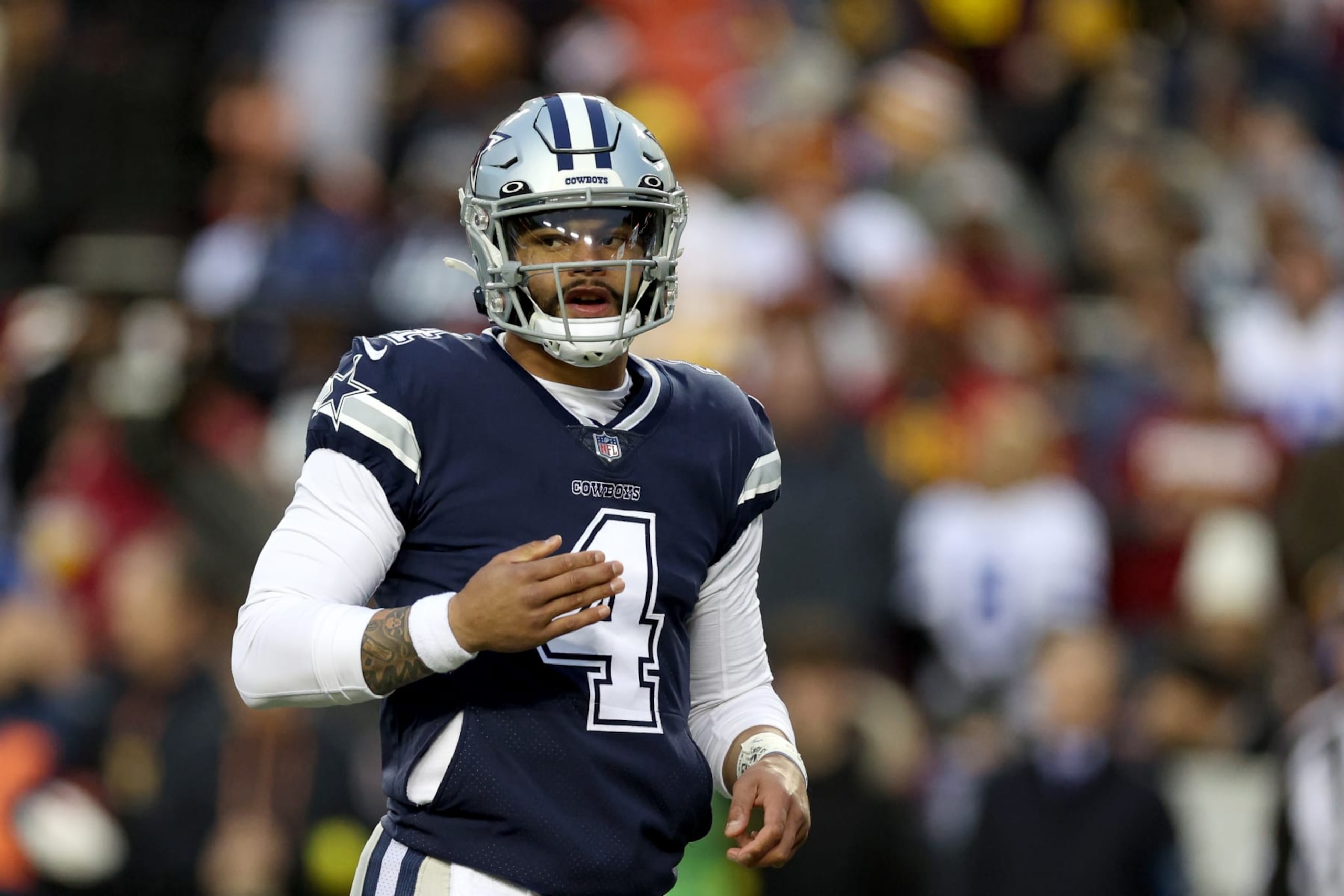 LANDOVER, MARYLAND - JANUARY 08: Quarterback Dak Prescott #4 of the Dallas Cowboys looks on against the Washington Commanders at FedExField on January 08, 2023 in Landover, Maryland. (Photo by Rob Carr/Getty Images)
