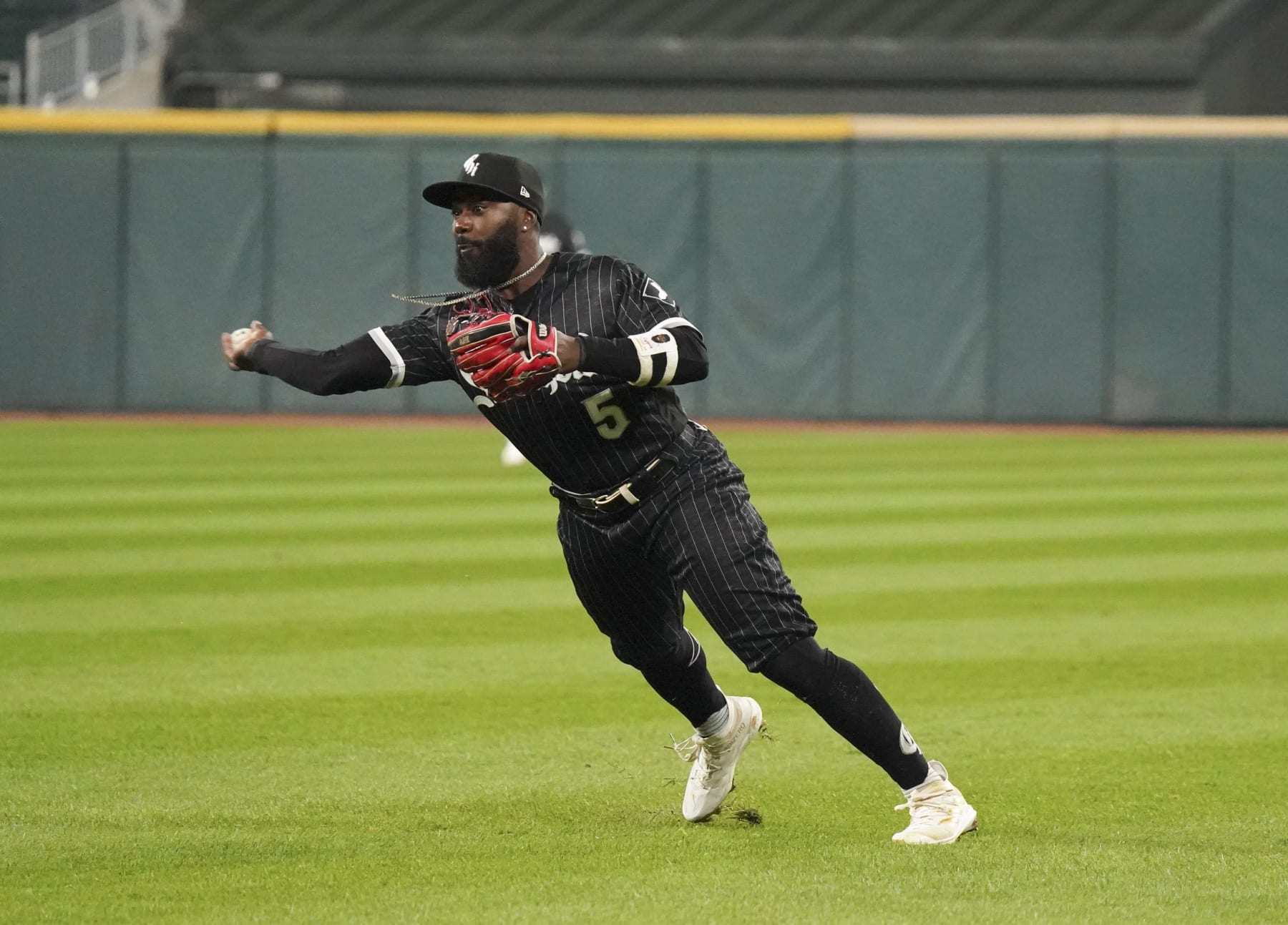 CHICAGO, ILLINOIS - OCTOBER 03: Josh Harrison #5 of the Chicago White Sox throws to first  during a game against the Minnesota Twins at Guaranteed Rate Field on October 03, 2022 in Chicago, Illinois. (Photo by Nuccio DiNuzzo/Getty Images)