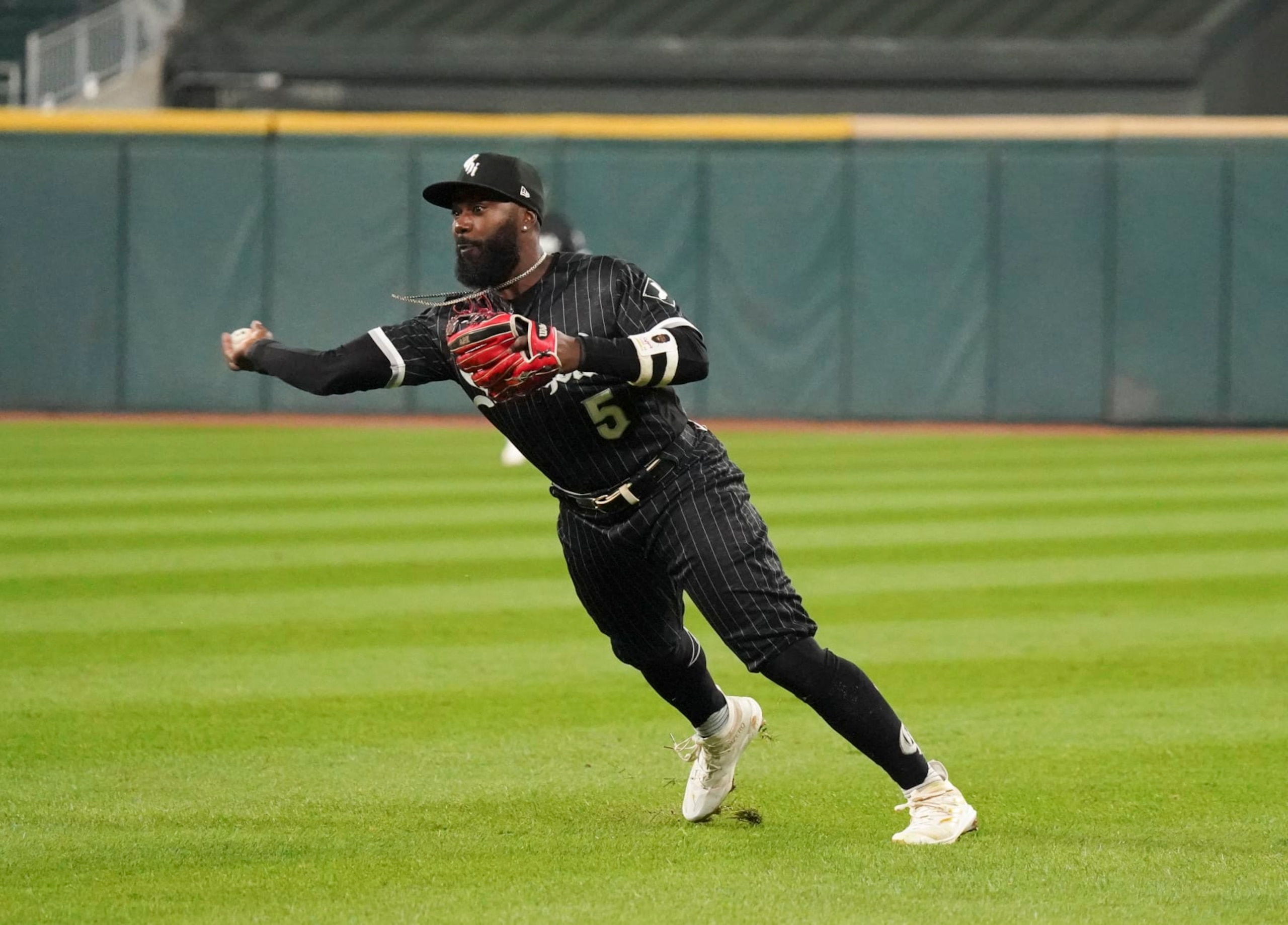 CHICAGO, ILLINOIS - OCTOBER 03: Josh Harrison #5 of the Chicago White Sox throws to first  during a game against the Minnesota Twins at Guaranteed Rate Field on October 03, 2022 in Chicago, Illinois. (Photo by Nuccio DiNuzzo/Getty Images)