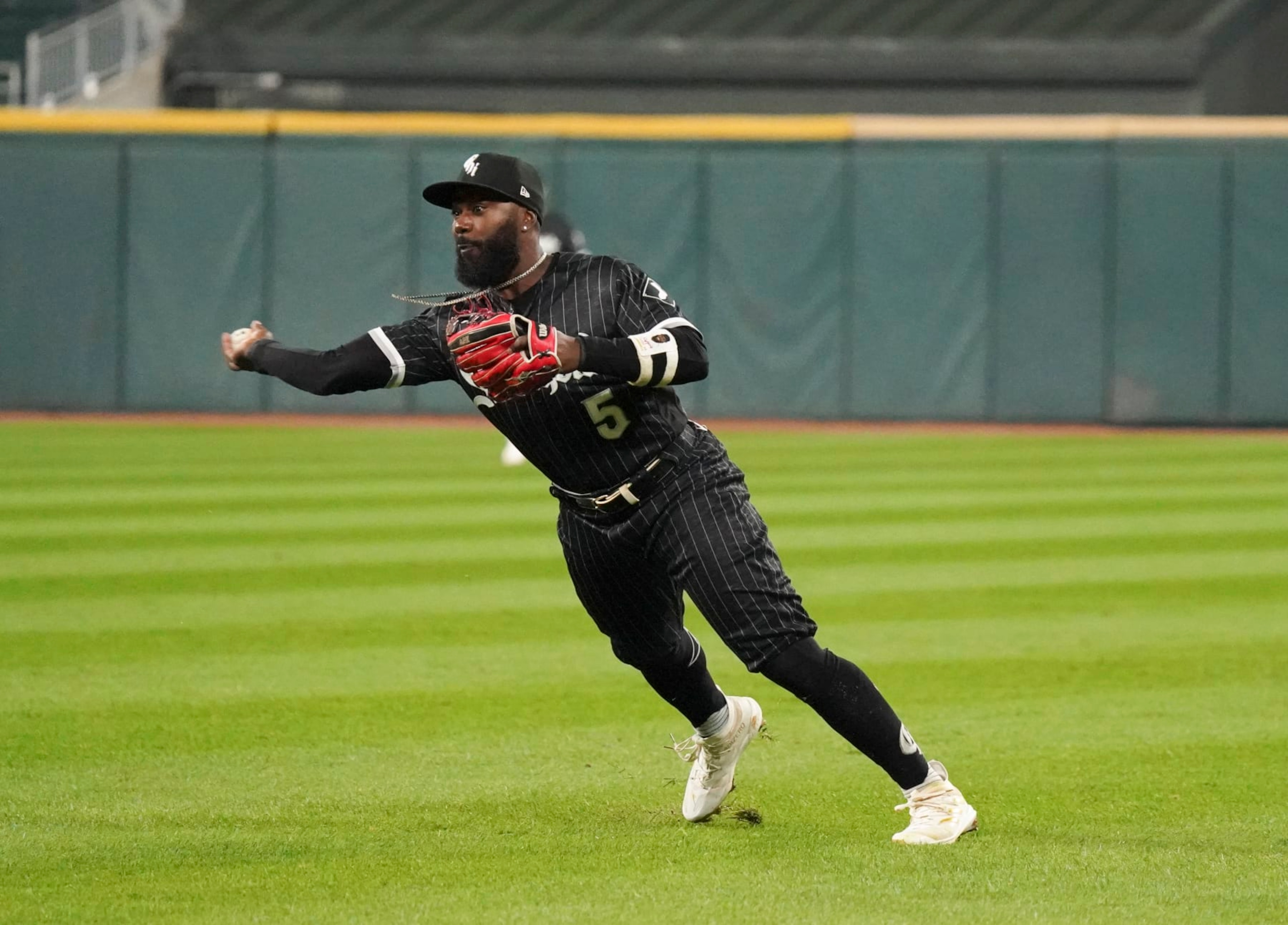 CHICAGO, ILLINOIS - OCTOBER 03: Josh Harrison #5 of the Chicago White Sox throws to first  during a game against the Minnesota Twins at Guaranteed Rate Field on October 03, 2022 in Chicago, Illinois. (Photo by Nuccio DiNuzzo/Getty Images)