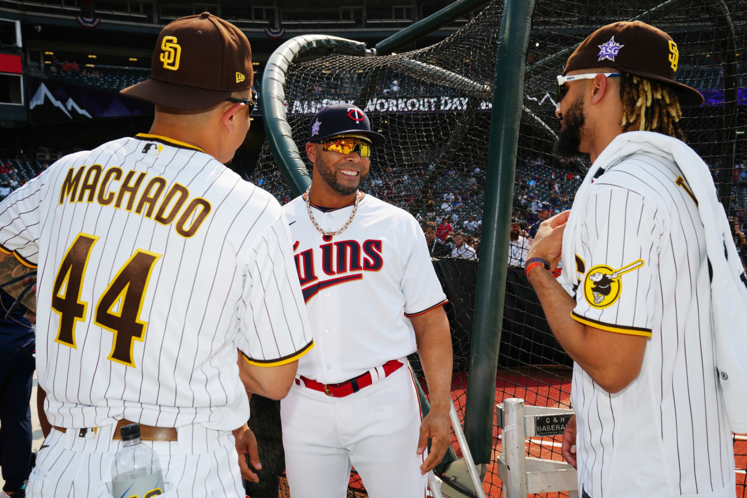 DENVER, CO - JULY 12:  Nelson Cruz #23 of the Minnesota Twins laughs with Manny Machado #13 and Fernando Tatis Jr. #23 of the San Diego Padres during the 2021 Gatorade All-Star Workout Day  at Coors Field on Monday, July 12, 2021 in Denver, Colorado. (Photo by Daniel Shirey/MLB Photos via Getty Images)