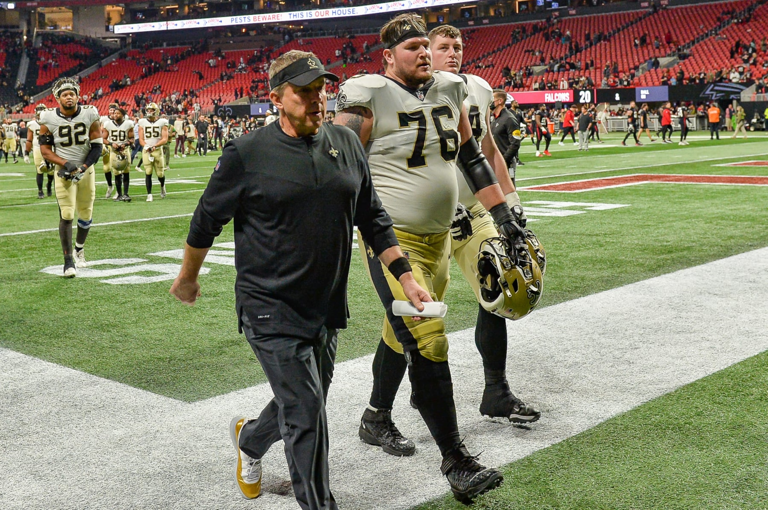 ATLANTA, GA  JANUARY 09:  New Orleans head coach Sean Payton leaves the field along with guard Calvin Throckmorton (76) following the conclusion of the New Orleans Saints and the Atlanta Falcons on January 9th, 2022 at Mercedes-Benz Stadium in Atlanta, GA.  (Photo by Rich von Biberstein/Icon Sportswire via Getty Images)