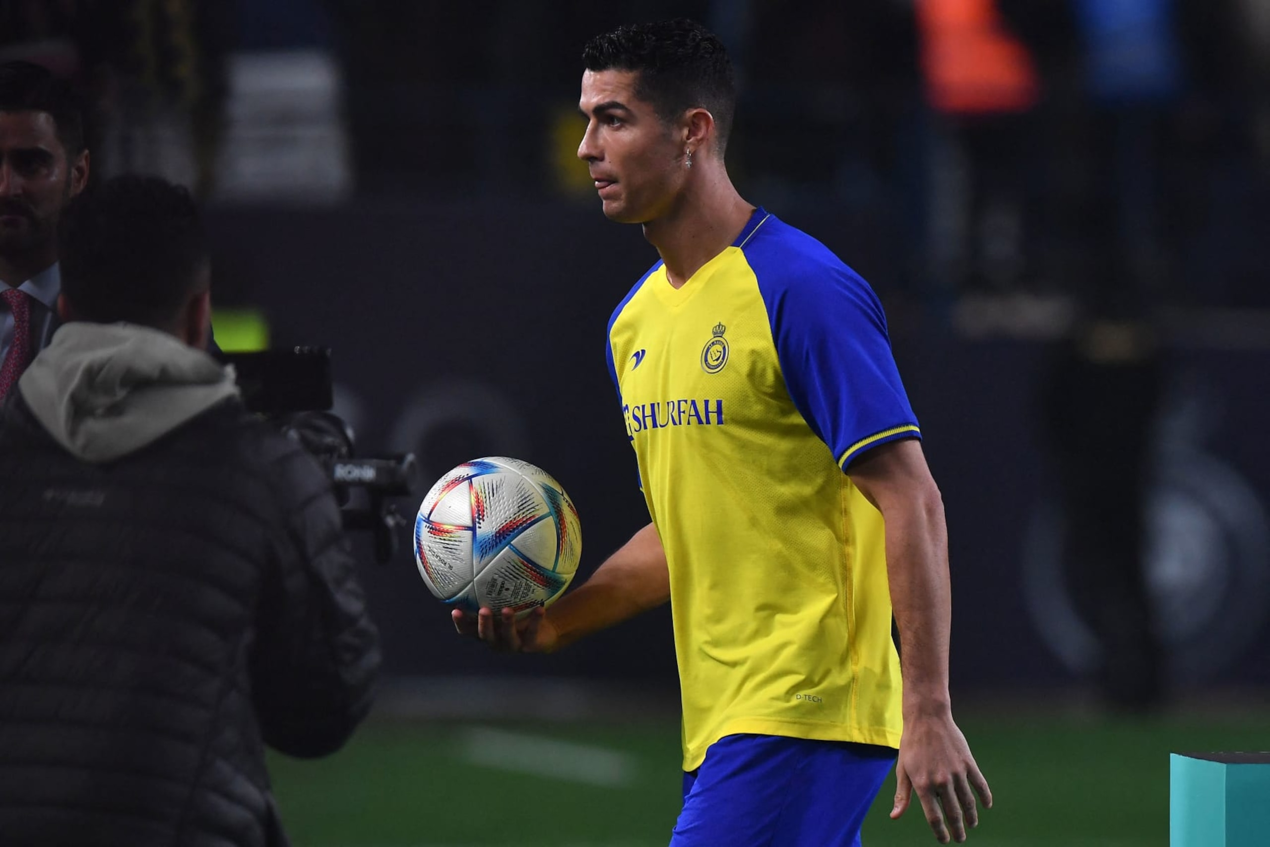 Al-Nassr's new Portuguese forward Cristiano Ronaldo carries a ball he autographed, to give the fans, during his unveiling at the Mrsool Park Stadium in the Saudi capital Riyadh on January 3, 2023. (Photo by AFP) (Photo by -/AFP via Getty Images) Al-Nassr's new Portuguese forward Cristiano Ronaldo carries a ball he autographed, to give the fans, during his unveiling at the Mrsool Park Stadium in the Saudi capital Riyadh on January 3, 2023. (Photo by AFP) (Photo by -/AFP via Getty Images)