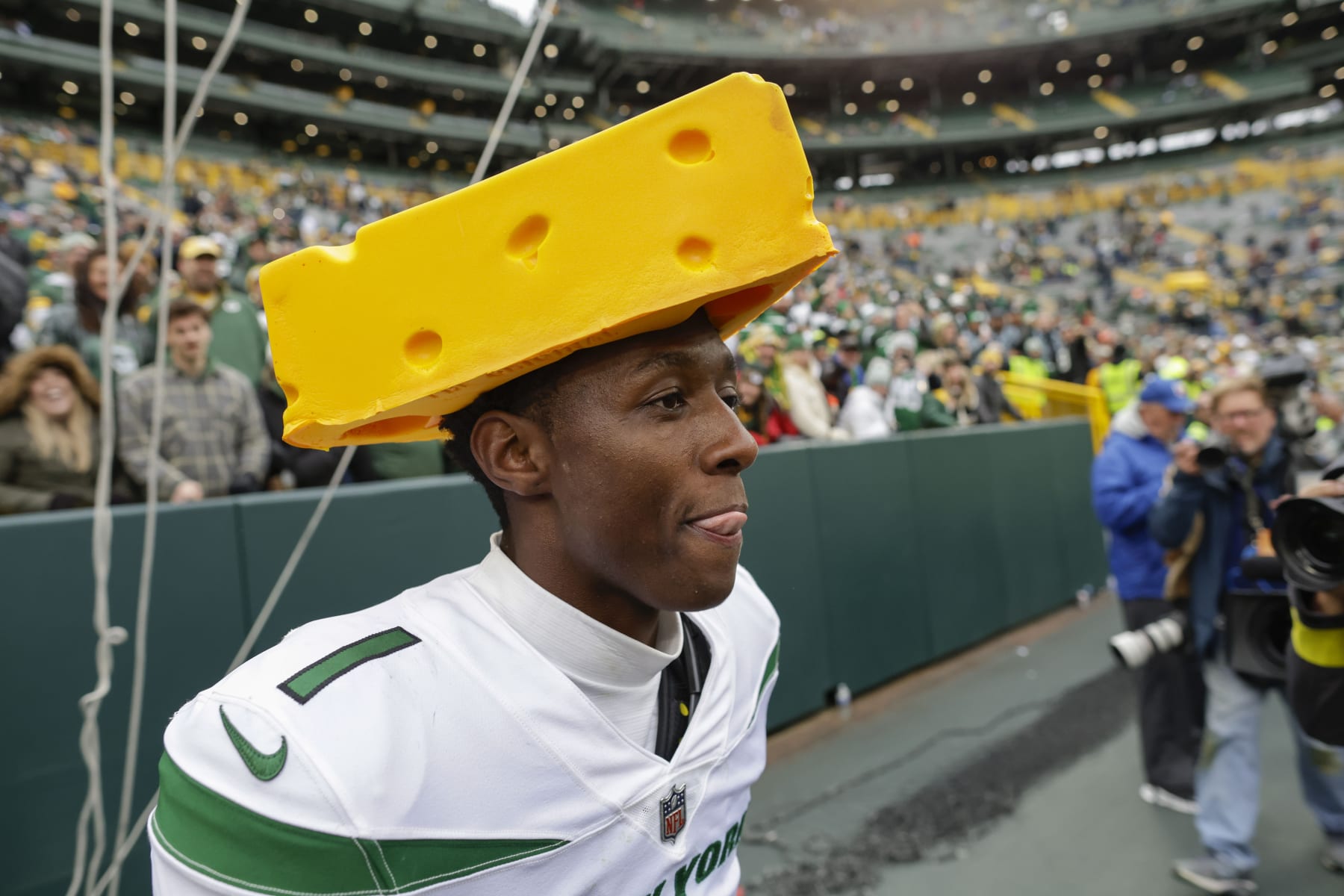New York Jets cornerback Sauce Gardner (1) walks off the field wearing a cheese head following an NFL football game against the Green Bay Packers Sunday, Oct. 16, 2022, in Green Bay, Wis. (AP Photo/Matt Ludtke)