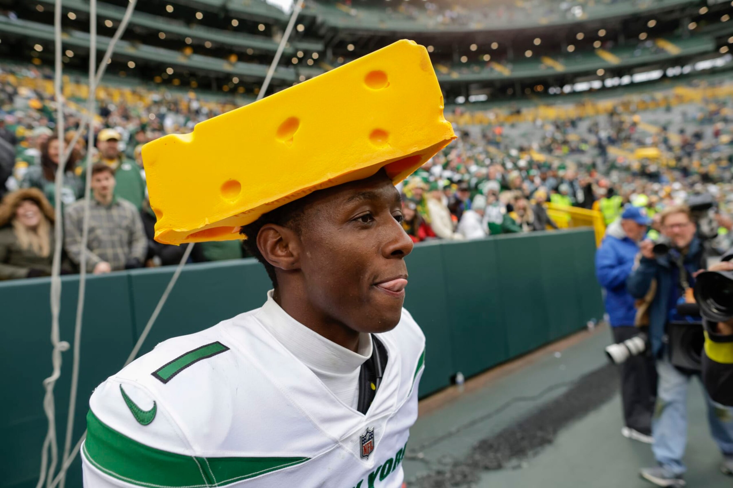 New York Jets cornerback Sauce Gardner (1) walks off the field wearing a cheese head following an NFL football game against the Green Bay Packers Sunday, Oct. 16, 2022, in Green Bay, Wis. (AP Photo/Matt Ludtke)