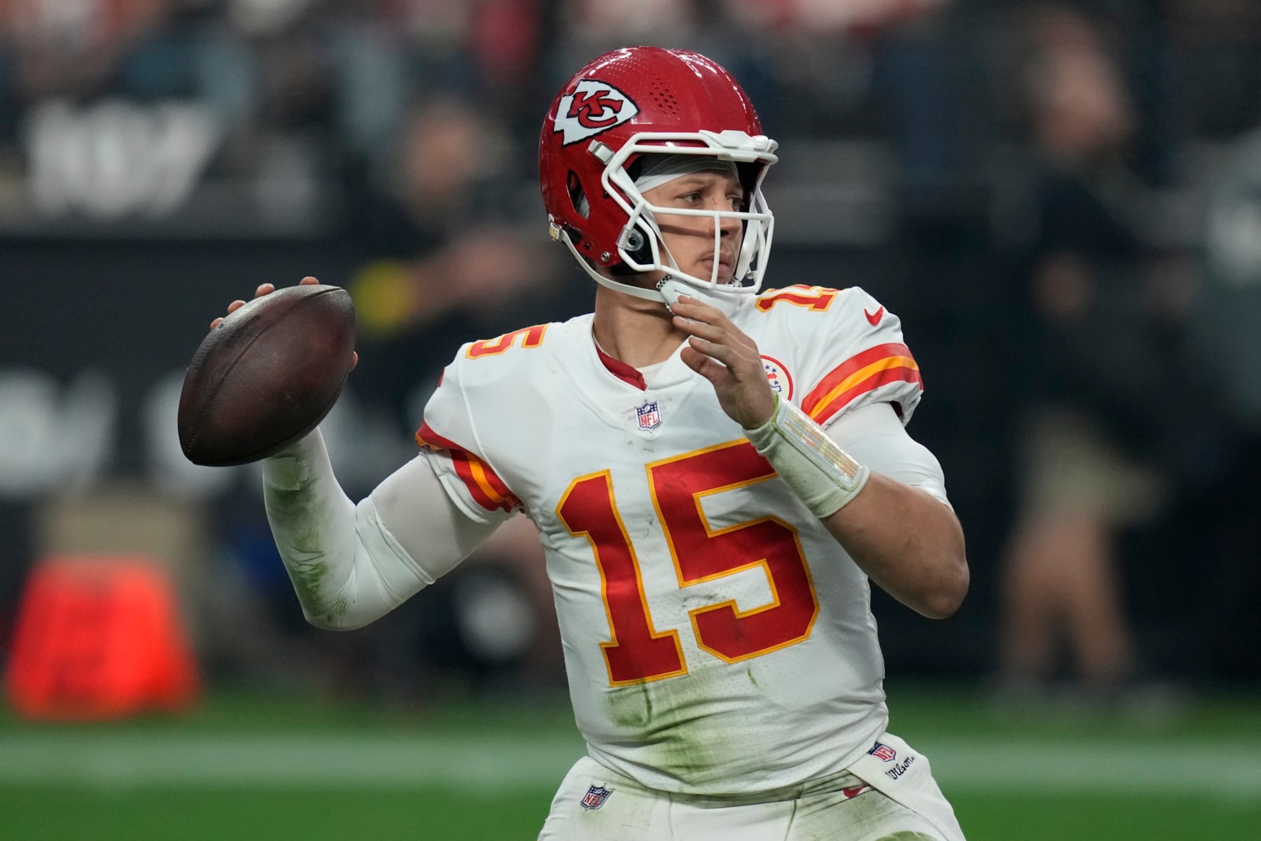 Kansas City Chiefs quarterback Patrick Mahomes (15) looks to throw against the Las Vegas Raiders during the second half of an NFL football game, Wednesday, Jan. 11, 2023, in Las Vegas. (AP Photo/John Locher)