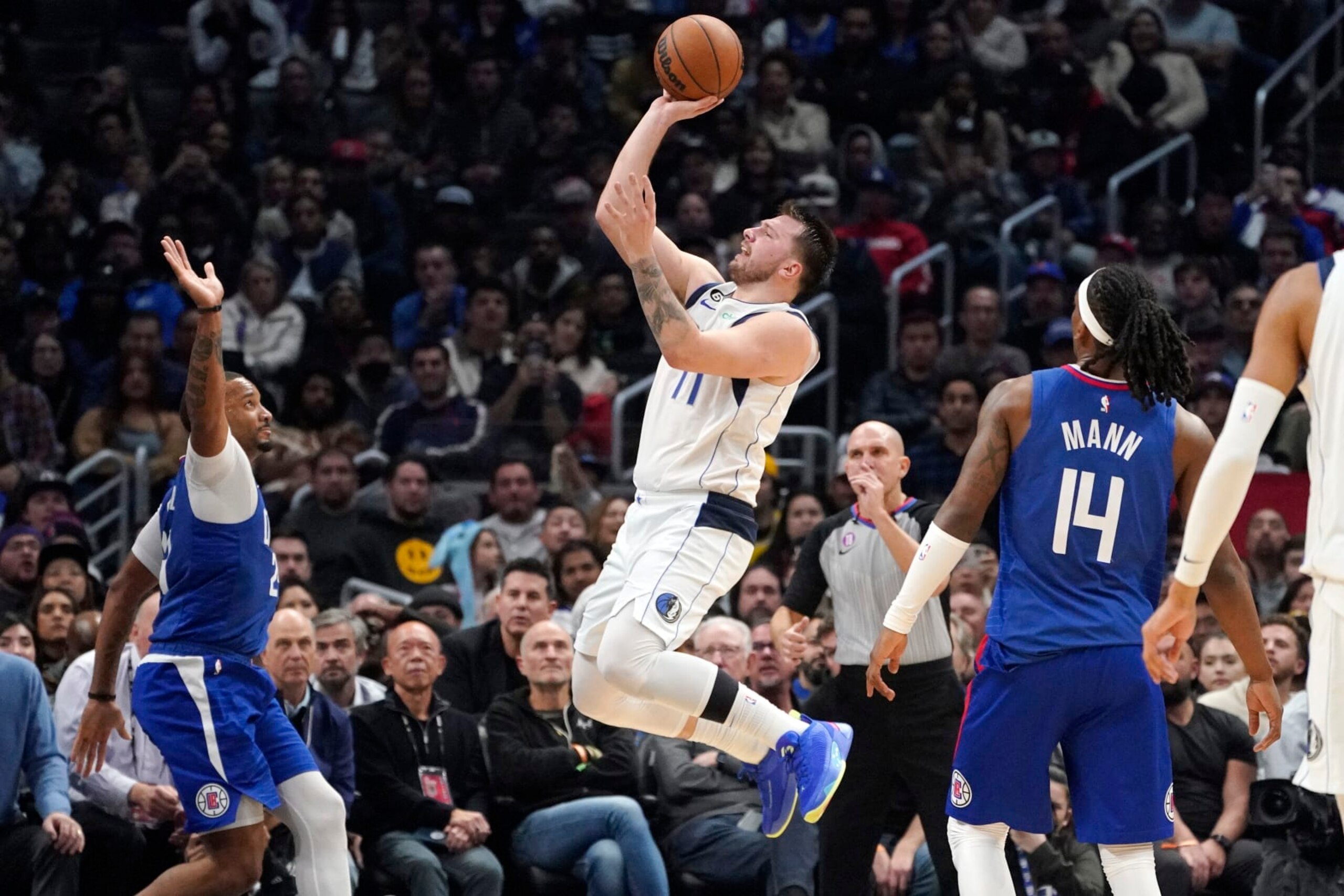 Dallas Mavericks guard Luka Doncic, center, shoots as Los Angeles Clippers forward Norman Powell, left, and guard Terance Mann defend during the second half of an NBA basketball game Tuesday, Jan. 10, 2023, in Los Angeles. (AP Photo/Mark J. Terrill) Dallas Mavericks guard Luka Doncic, center, shoots as Los Angeles Clippers forward Norman Powell, left, and guard Terance Mann defend during the second half of an NBA basketball game Tuesday, Jan. 10, 2023, in Los Angeles. (AP Photo/Mark J. Terrill)