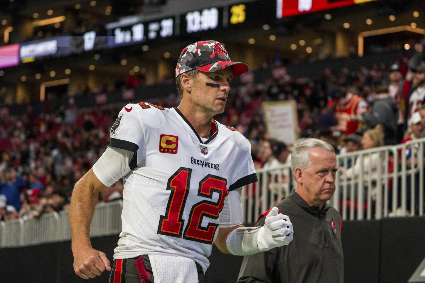 Tampa Bay Buccaneers quarterback Tom Brady (12) runs off the field after the first half of an NFL football game against the Atlanta Falcons, Sunday, Jan. 8, 2023, in Atlanta. (AP Photo/Danny Karnik)