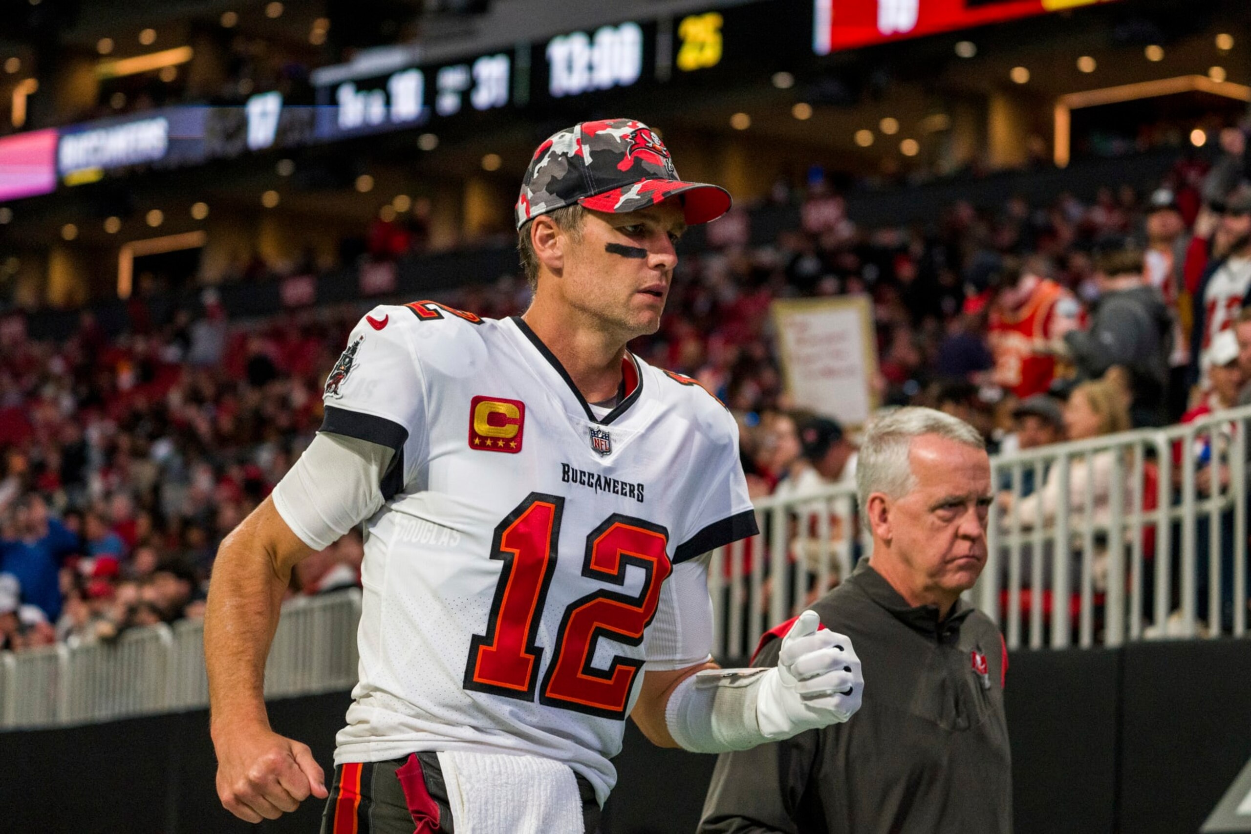 Tampa Bay Buccaneers quarterback Tom Brady (12) runs off the field after the first half of an NFL football game against the Atlanta Falcons, Sunday, Jan. 8, 2023, in Atlanta. (AP Photo/Danny Karnik)