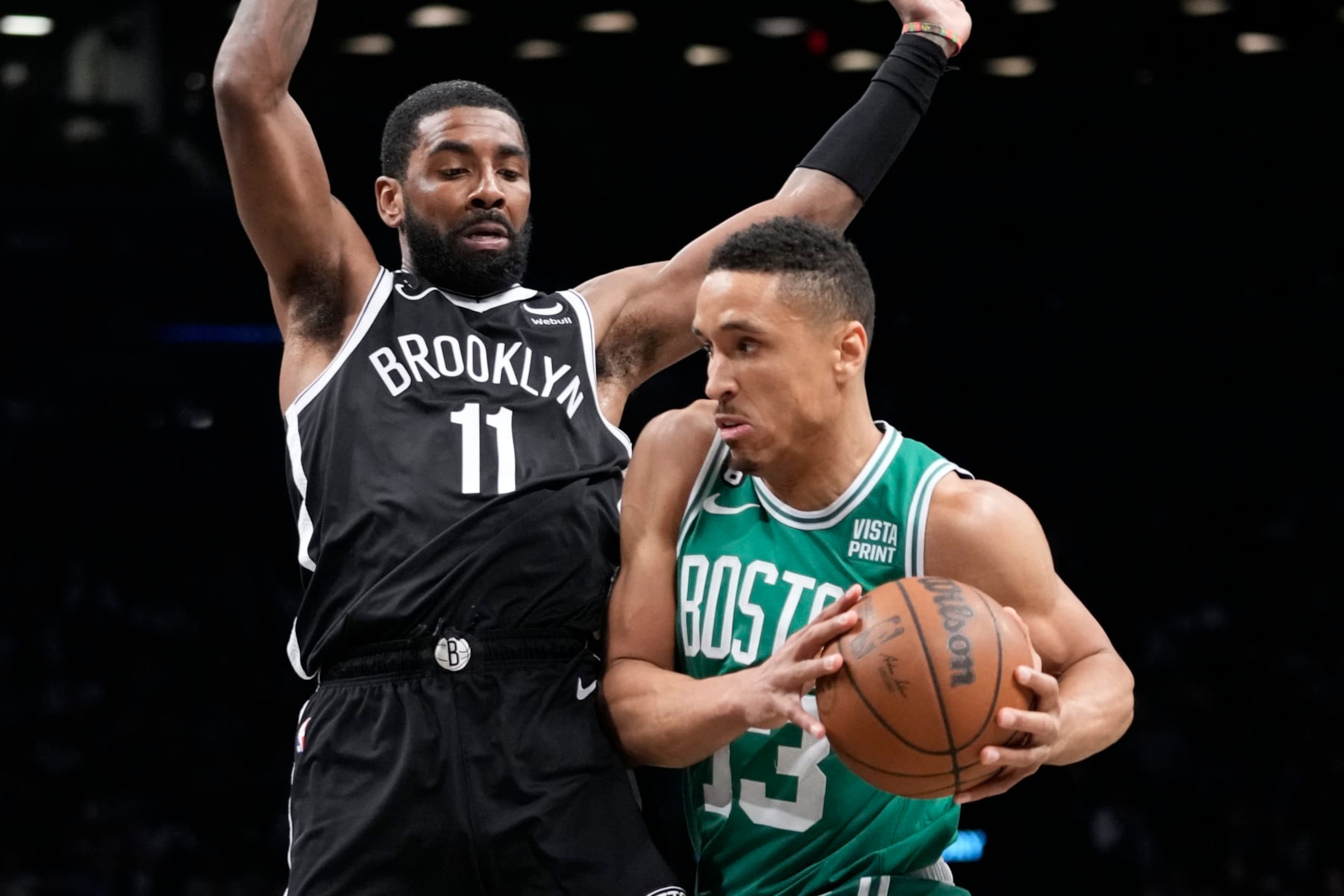 Boston Celtics guard Malcolm Brogdon (13) drives against Brooklyn Nets guard Kyrie Irving (11) during the first half of an NBA basketball game Thursday, Jan. 12, 2023, in New York. (AP Photo/Mary Altaffer) Boston Celtics guard Malcolm Brogdon (13) drives against Brooklyn Nets guard Kyrie Irving (11) during the first half of an NBA basketball game Thursday, Jan. 12, 2023, in New York. (AP Photo/Mary Altaffer)