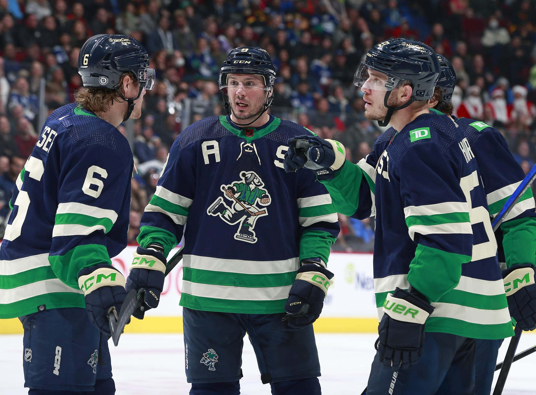 VANCOUVER, CANADA - DECEMBER 19: J.T. Miller #9 of the Vancouver Canucks talks to teammates Brock Boeser #6 and Bo Horvat #53 during their NHL game against the St. Louis Blues at Rogers Arena December 19, 2022 in Vancouver, British Columbia, Canada.  (Photo by Jeff Vinnick/NHLI via Getty Images)