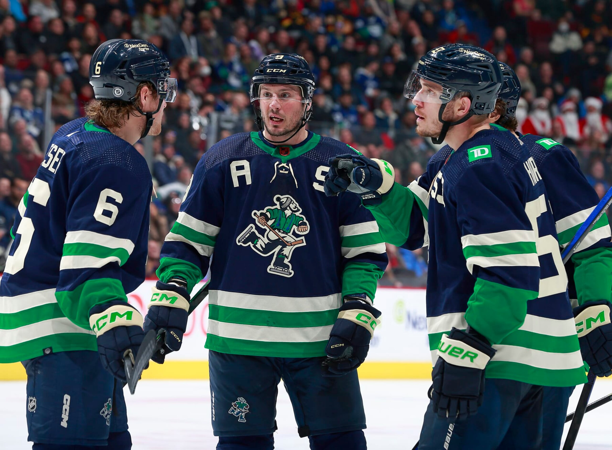VANCOUVER, CANADA - DECEMBER 19: J.T. Miller #9 of the Vancouver Canucks talks to teammates Brock Boeser #6 and Bo Horvat #53 during their NHL game against the St. Louis Blues at Rogers Arena December 19, 2022 in Vancouver, British Columbia, Canada.  (Photo by Jeff Vinnick/NHLI via Getty Images)