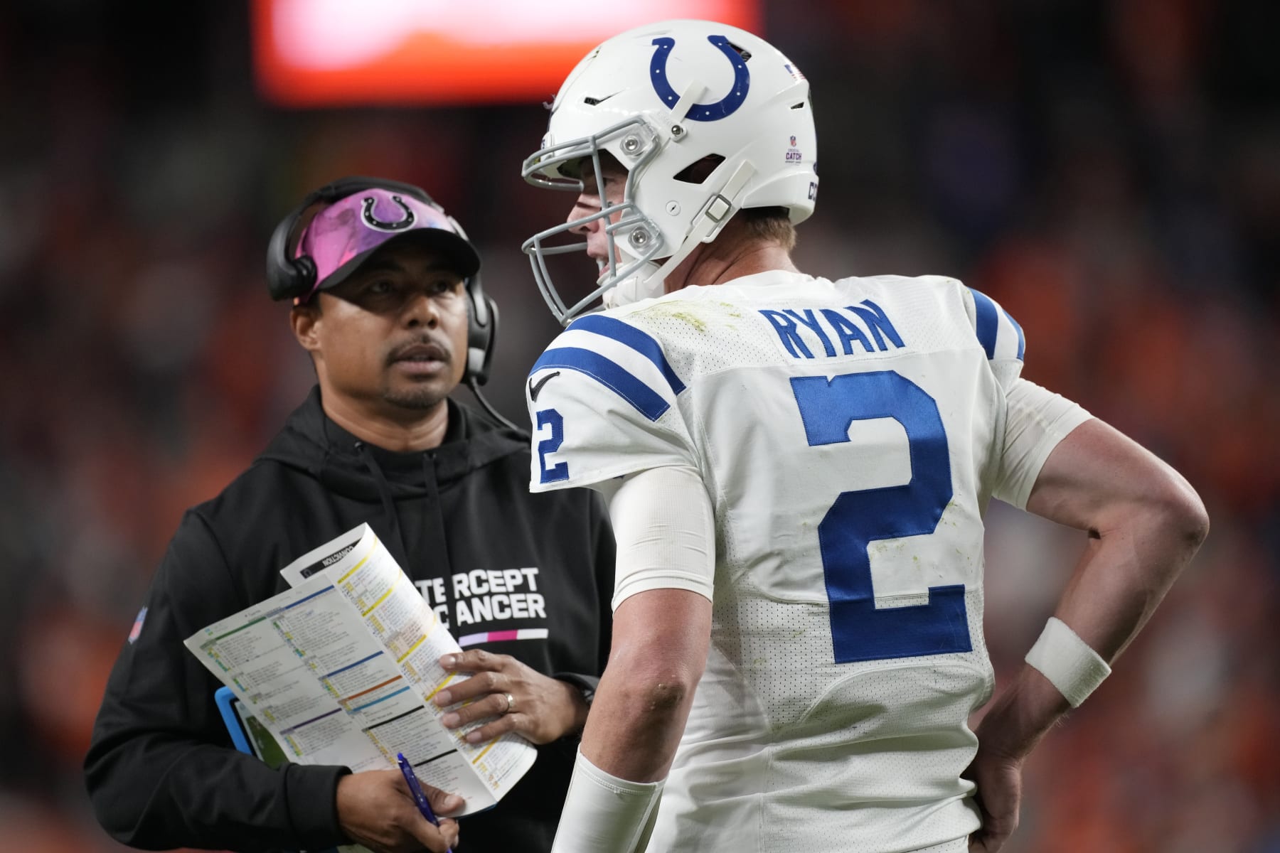 Indianapolis Colts quarterback Matt Ryan (2) confers with Indianapolis Colts offensive coordinator Marcus Brady in the second half of an NFL football game Thursday, Oct. 6, 2022, in Denver. (AP Photo/David Zalubowski)