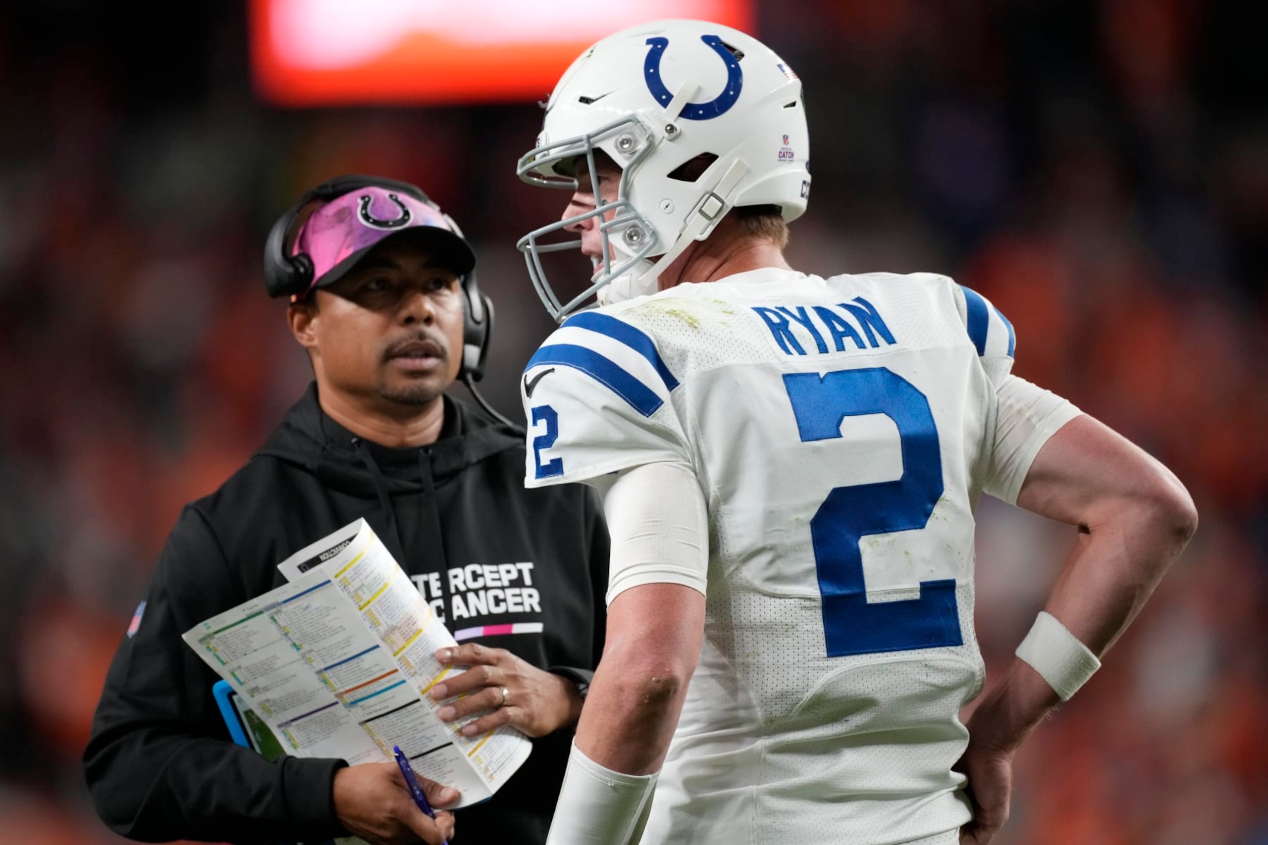Indianapolis Colts quarterback Matt Ryan (2) confers with Indianapolis Colts offensive coordinator Marcus Brady in the second half of an NFL football game Thursday, Oct. 6, 2022, in Denver. (AP Photo/David Zalubowski)