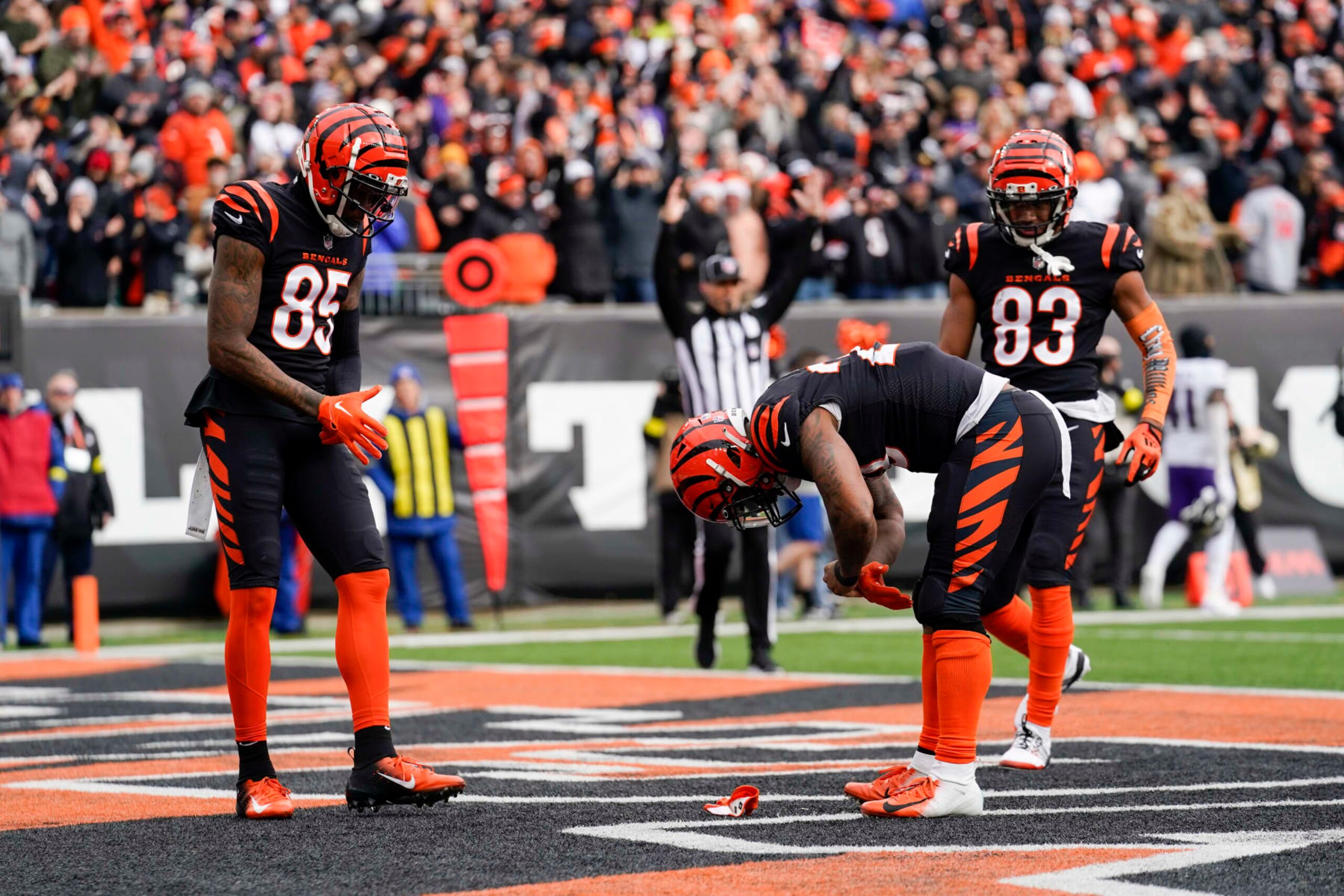 Cincinnati Bengals running back Joe Mixon (28) reaches for a coin in his glove after scoring a touchdown during an NFL football game against the Baltimore Ravens, Sunday, Jan. 8, 2023, in Cincinnati. (AP Photo/Jeff Dean)