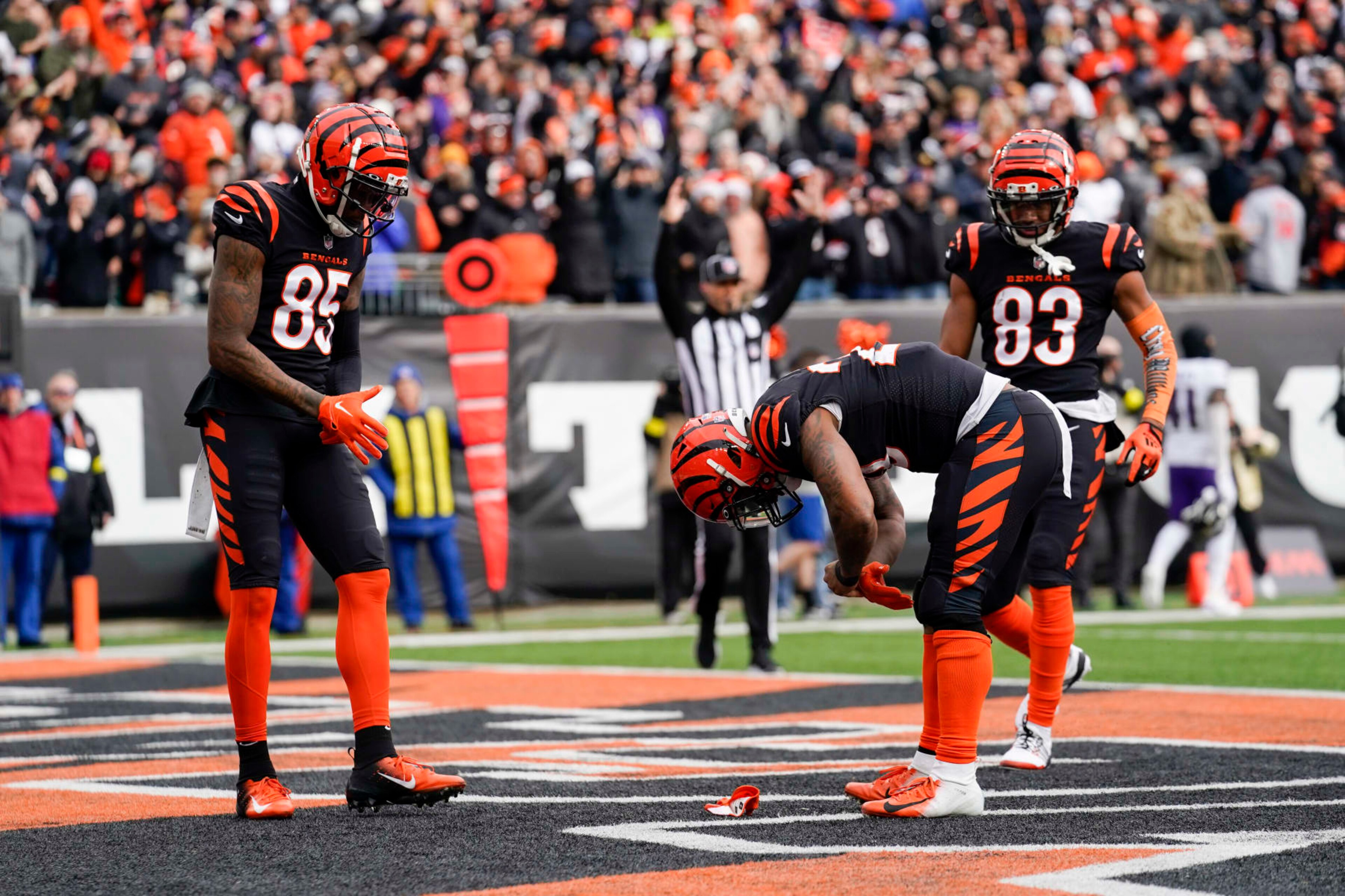 Cincinnati Bengals running back Joe Mixon (28) reaches for a coin in his glove after scoring a touchdown during an NFL football game against the Baltimore Ravens, Sunday, Jan. 8, 2023, in Cincinnati. (AP Photo/Jeff Dean)