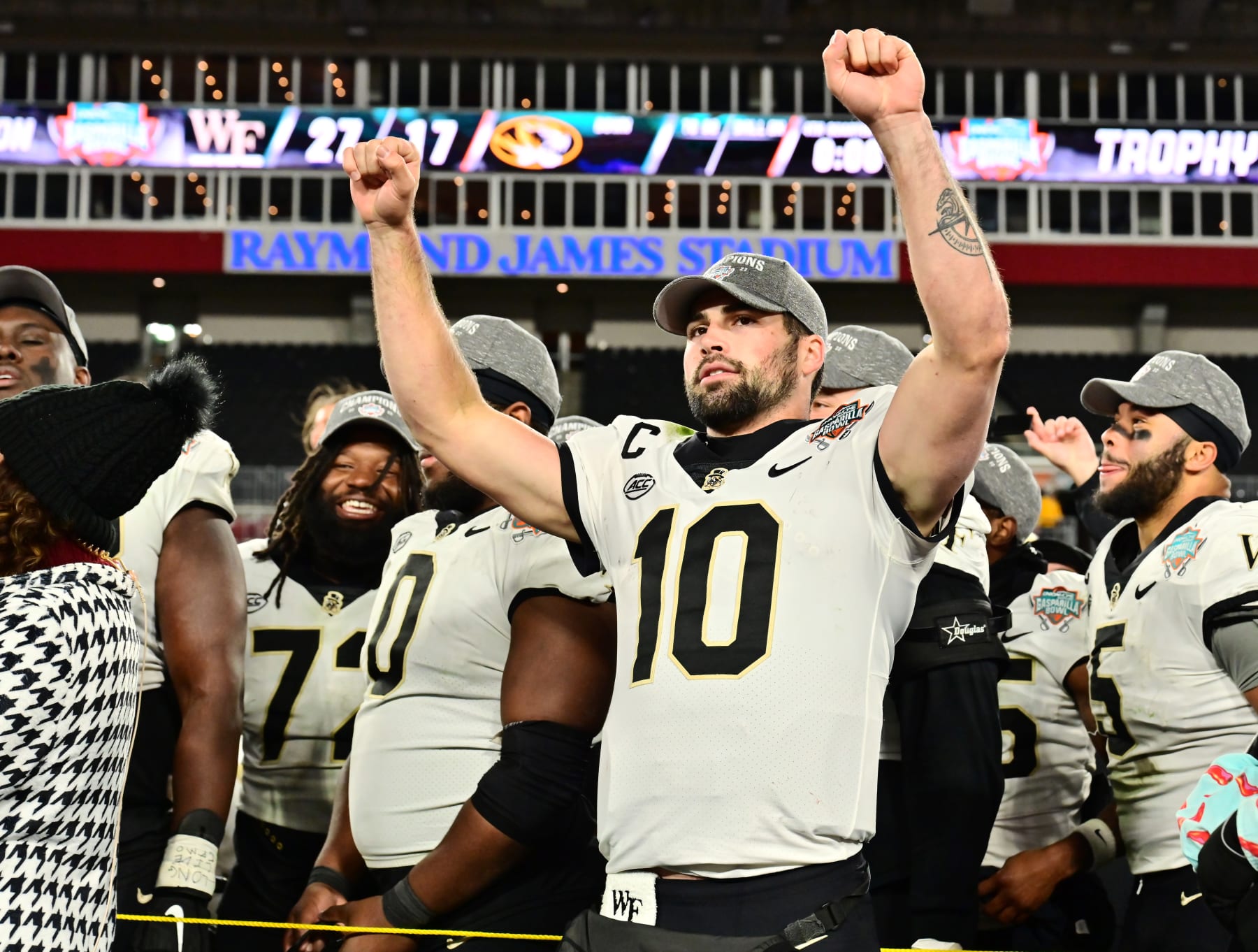TAMPA, FLORIDA - DECEMBER 23: Sam Hartman #10 of the Wake Forest Demon Deacons reacts after receiving the most valuable player award following the Union Home Mortgage Gasparilla Bowl at Raymond James Stadium on December 23, 2022 in Tampa, Florida. The Wake Forest Demon Deacons defeated the Missouri Tigers 27-17. (Photo by Julio Aguilar/Getty Images)