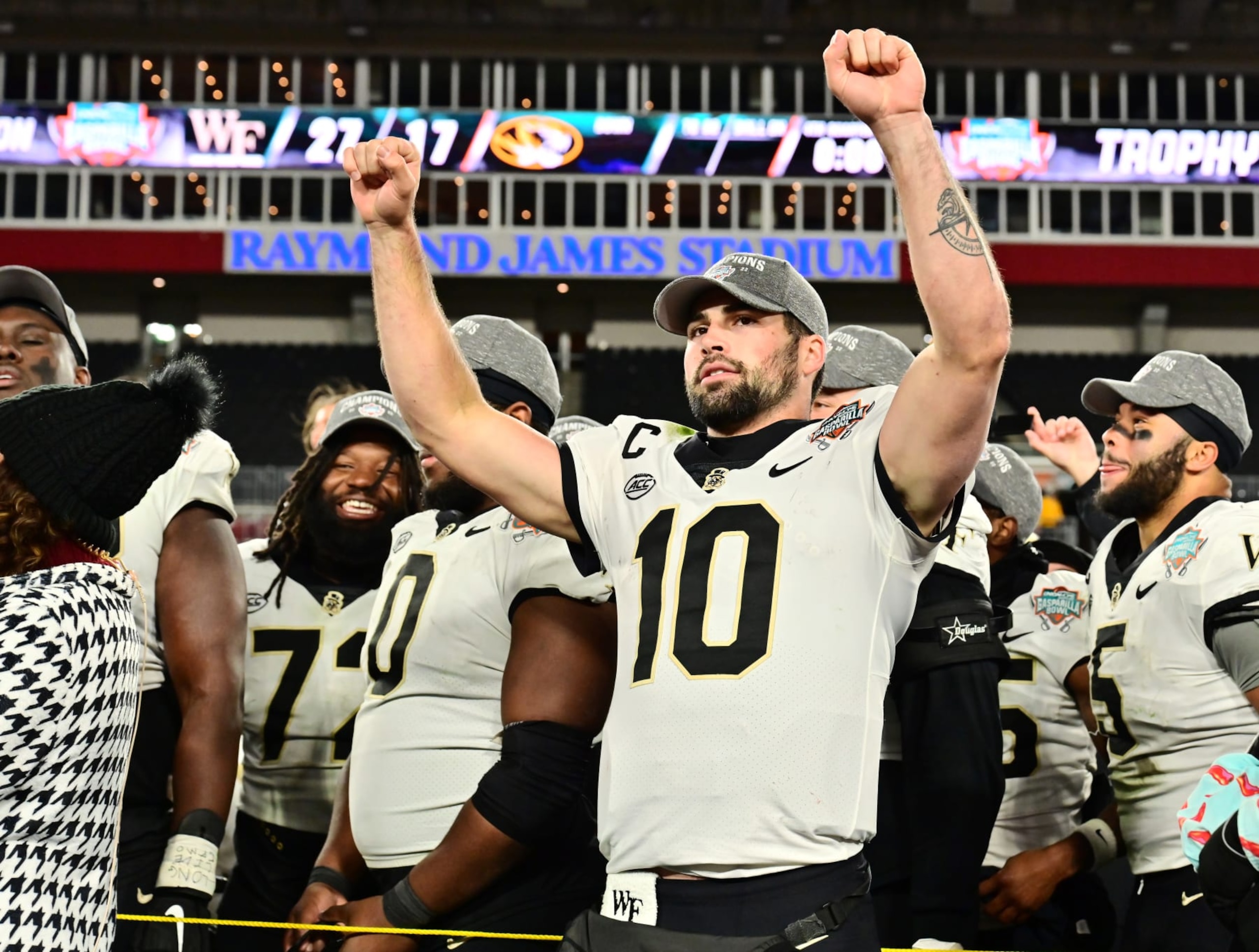 TAMPA, FLORIDA - DECEMBER 23: Sam Hartman #10 of the Wake Forest Demon Deacons reacts after receiving the most valuable player award following the Union Home Mortgage Gasparilla Bowl at Raymond James Stadium on December 23, 2022 in Tampa, Florida. The Wake Forest Demon Deacons defeated the Missouri Tigers 27-17. (Photo by Julio Aguilar/Getty Images)