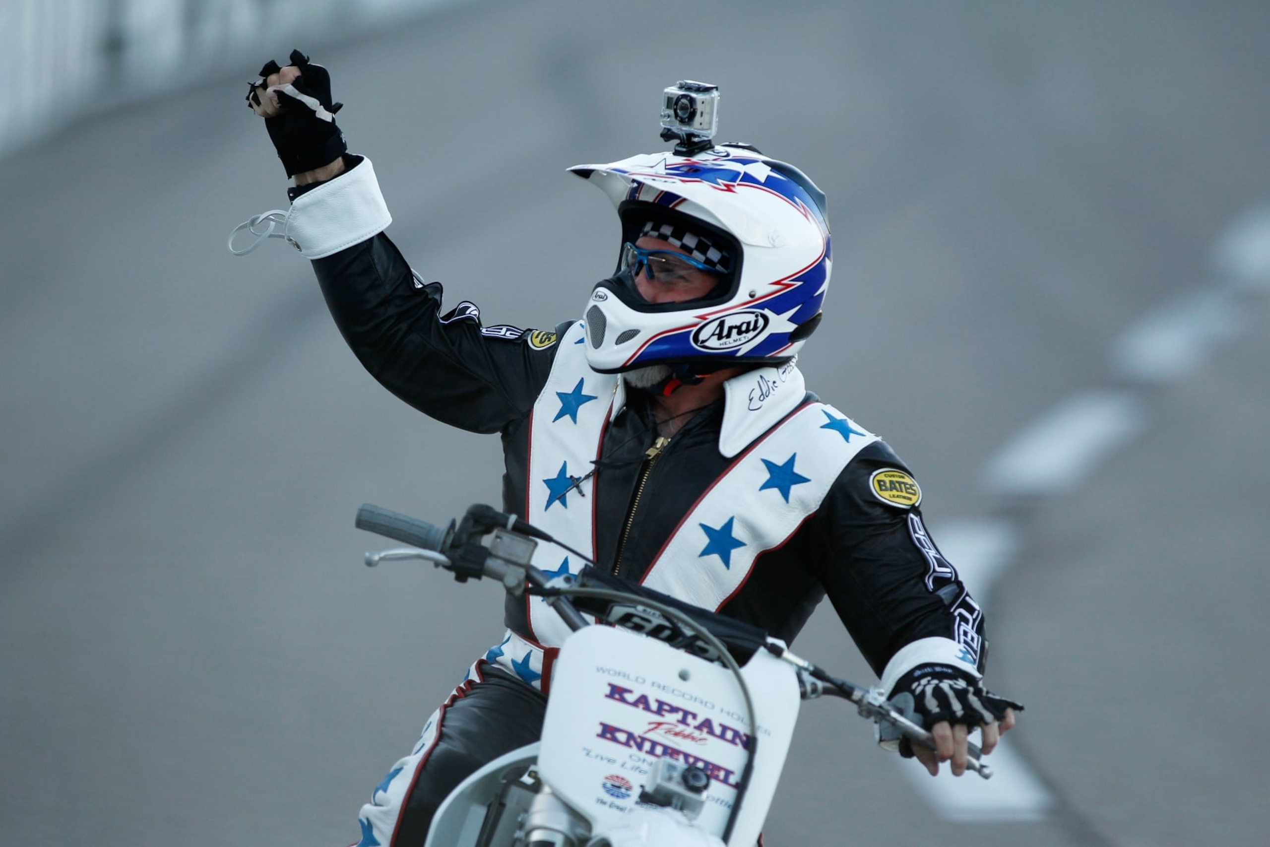 FORT WORTH, TX - JUNE 05:  Motorcycle daredevil Robbie Knievel celebrates after jumping a line of police cars, ambulances and a fire truck spanning 200 feet in his "Above the Law" jump prior to the IZOD IndyCar Series Firestone 550k at Texas Motor Speedway June 5, 2010 in Fort Worth, Texas.  (Photo by Jonathan Ferrey/Getty Images)