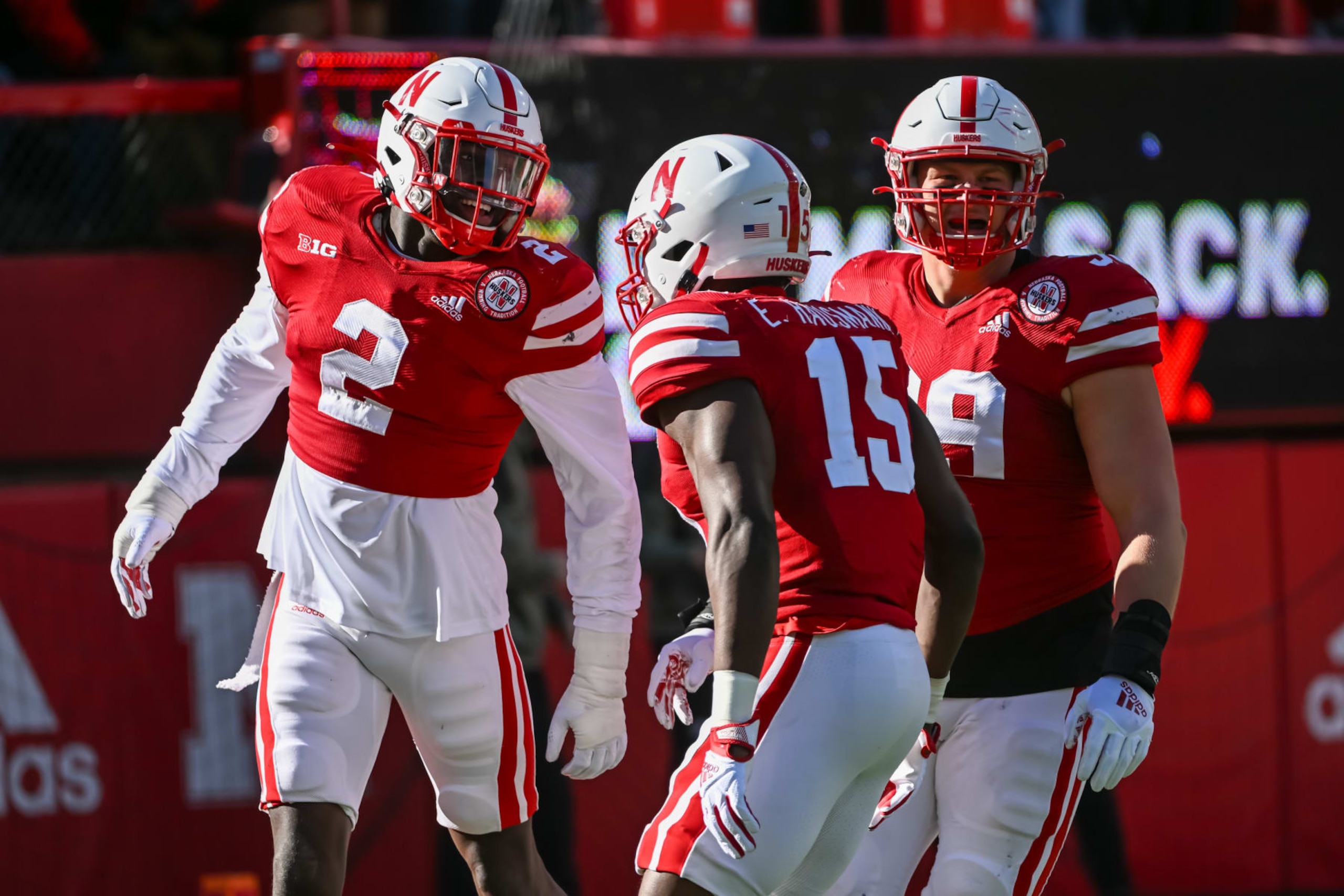 LINCOLN, NE - NOVEMBER 05: Defensive end Caleb Tannor #2 of the Nebraska Cornhuskers celebrates a stop with linebacker Ernest Hausmann #15 and defensive lineman Ty Robinson #99 against the Minnesota Golden Gophers during the first quarter at Memorial Stadium on November 5, 2022 in Lincoln, Nebraska. (Photo by Steven Branscombe/Getty Images)