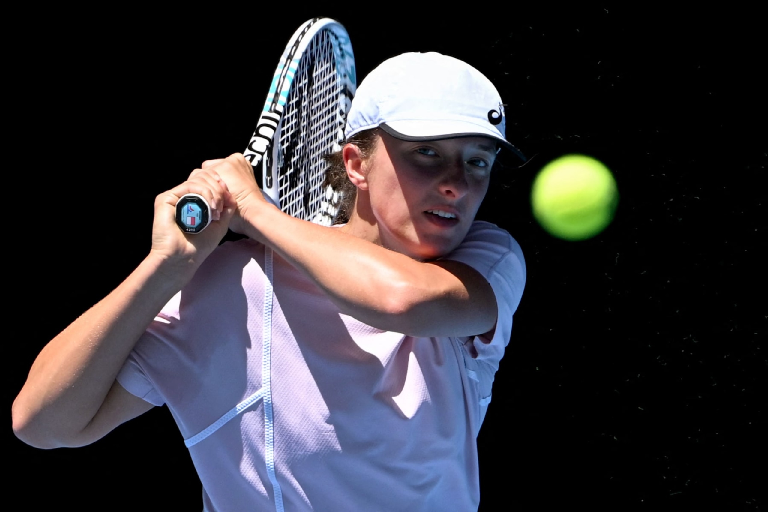 Poland's Iga Swiatek hits a return during a practice session ahead of the Australian Open tennis tournament in Melbourne on January 11, 2023. - -- IMAGE RESTRICTED TO EDITORIAL USE - STRICTLY NO COMMERCIAL USE -- (Photo by William WEST / AFP) / -- IMAGE RESTRICTED TO EDITORIAL USE - STRICTLY NO COMMERCIAL USE -- (Photo by WILLIAM WEST/AFP via Getty Images)
