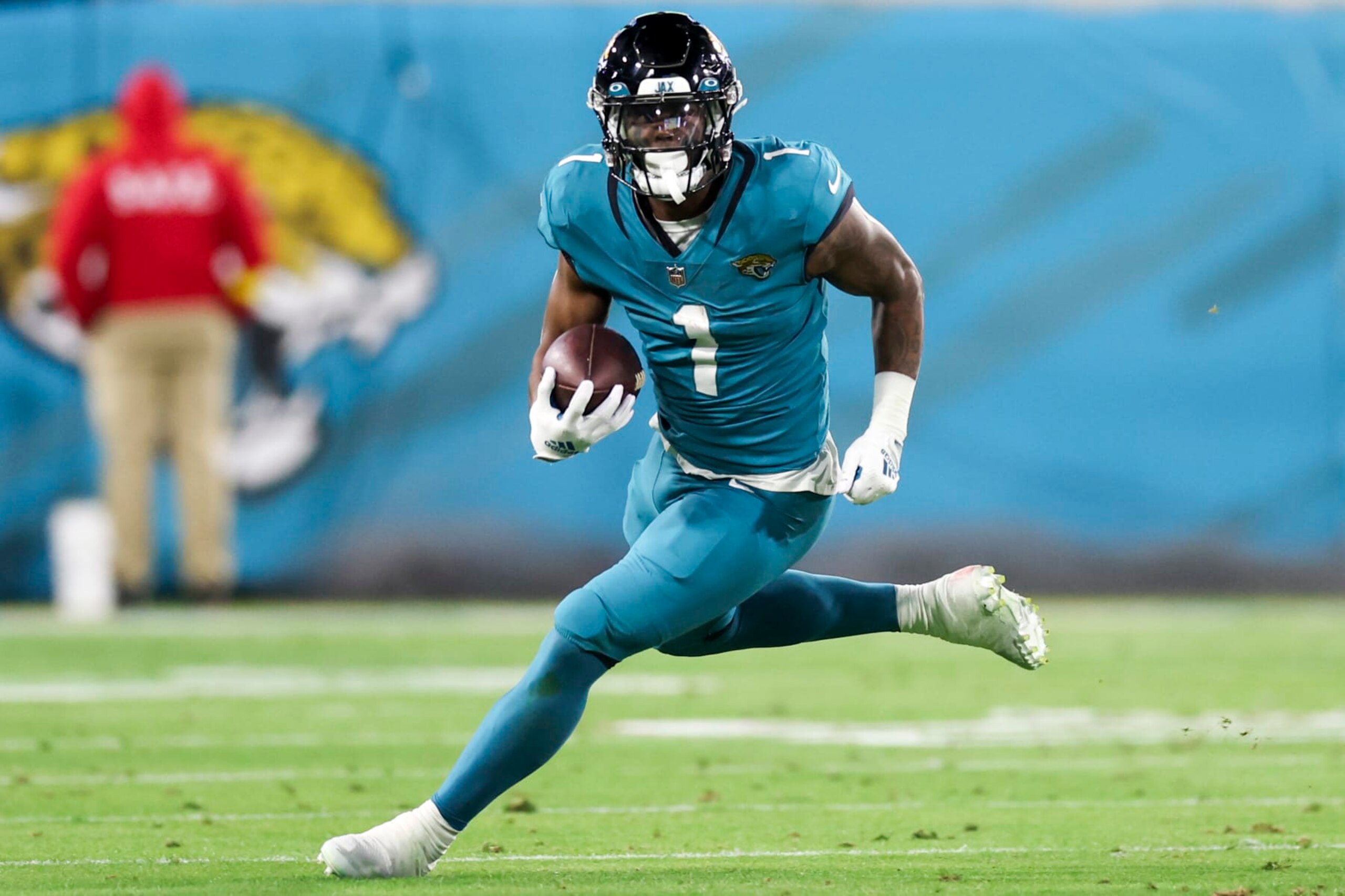 JACKSONVILLE, FLORIDA - JANUARY 07: Travis Etienne Jr. #1 of the Jacksonville Jaguars runs the ball during the second quarter against the Tennessee Titans at TIAA Bank Field on January 07, 2023 in Jacksonville, Florida. (Photo by Mike Carlson/Getty Images)