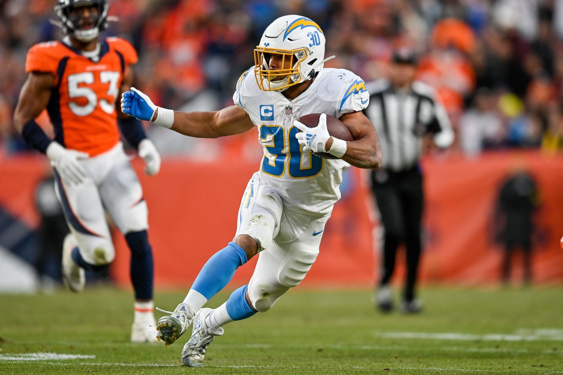 DENVER, CO - JANUARY 8: Los Angeles Chargers running back Austin Ekeler (30) carries the ball during a game between the Los Angeles Chargers and the Denver Broncos at Empower Field at Mile High on January 8, 2023 in Denver, Colorado. (Photo by Dustin Bradford/Icon Sportswire via Getty Images)
