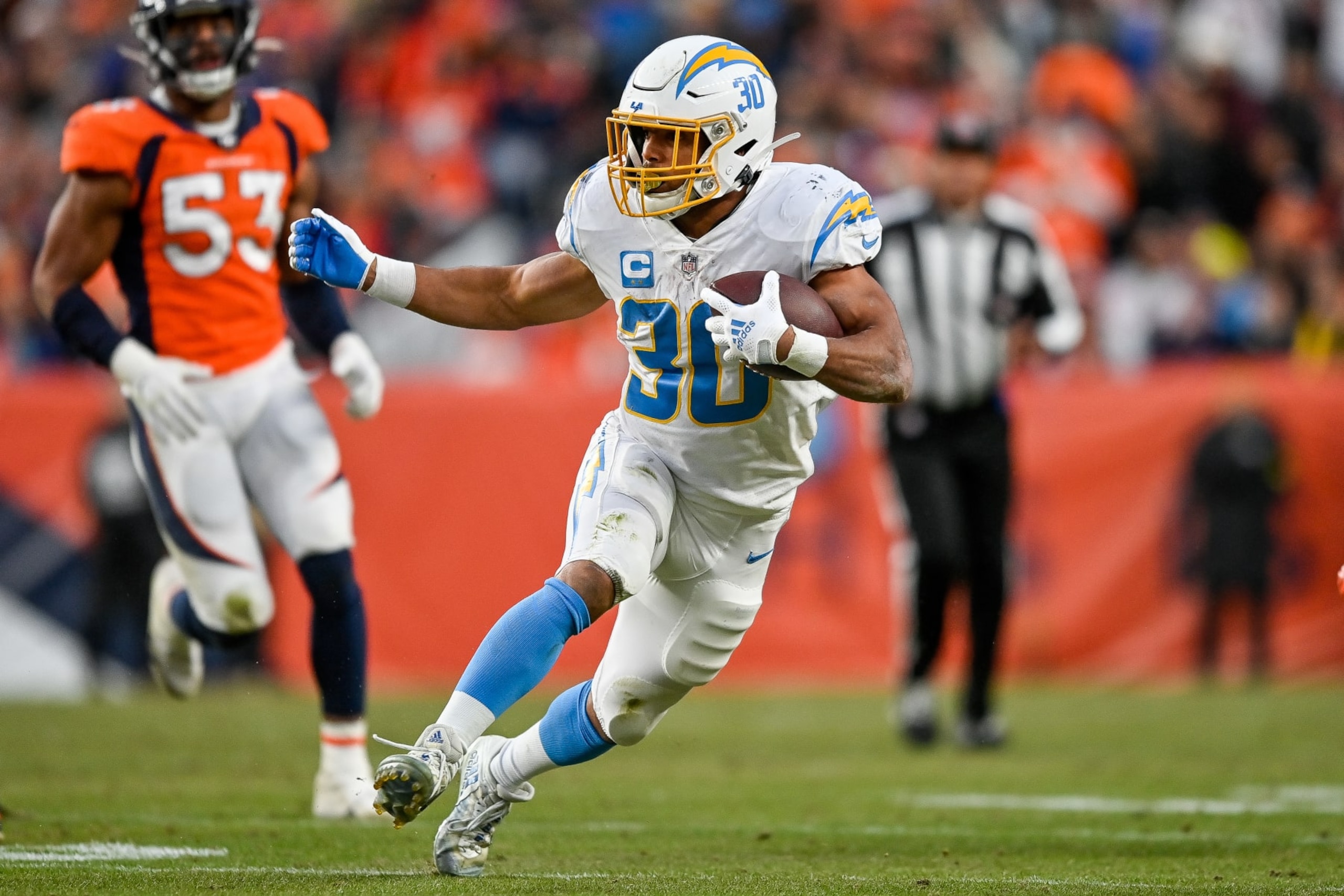 DENVER, CO - JANUARY 8: Los Angeles Chargers running back Austin Ekeler (30) carries the ball during a game between the Los Angeles Chargers and the Denver Broncos at Empower Field at Mile High on January 8, 2023 in Denver, Colorado. (Photo by Dustin Bradford/Icon Sportswire via Getty Images)