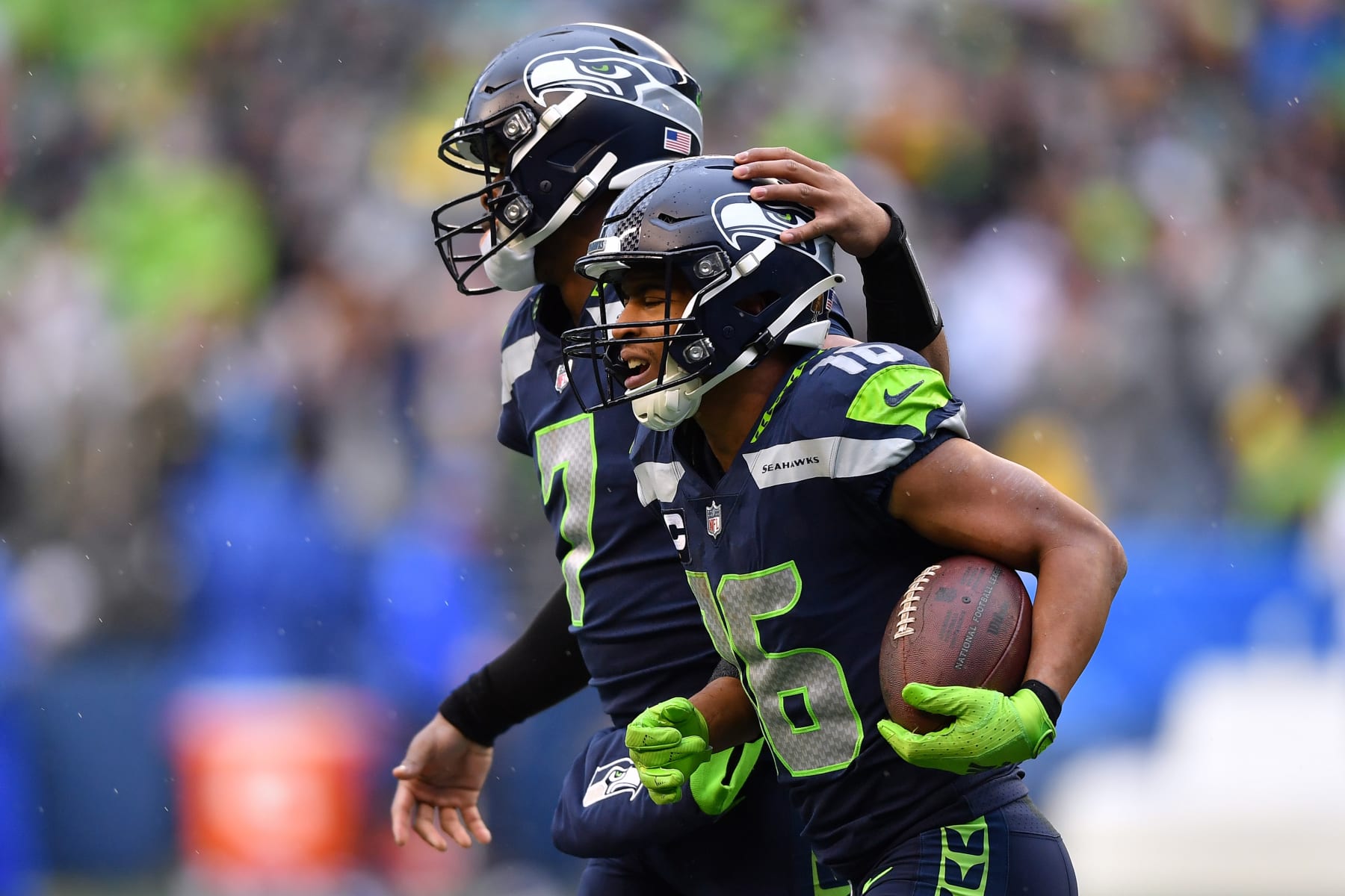 SEATTLE, WASHINGTON - JANUARY 08: Tyler Lockett #16 of the Seattle Seahawks celebrates his touchdown catch with Geno Smith #7 during the third quarter against the Los Angeles Rams at Lumen Field on January 08, 2023 in Seattle, Washington. (Photo by Jane Gershovich/Getty Images)