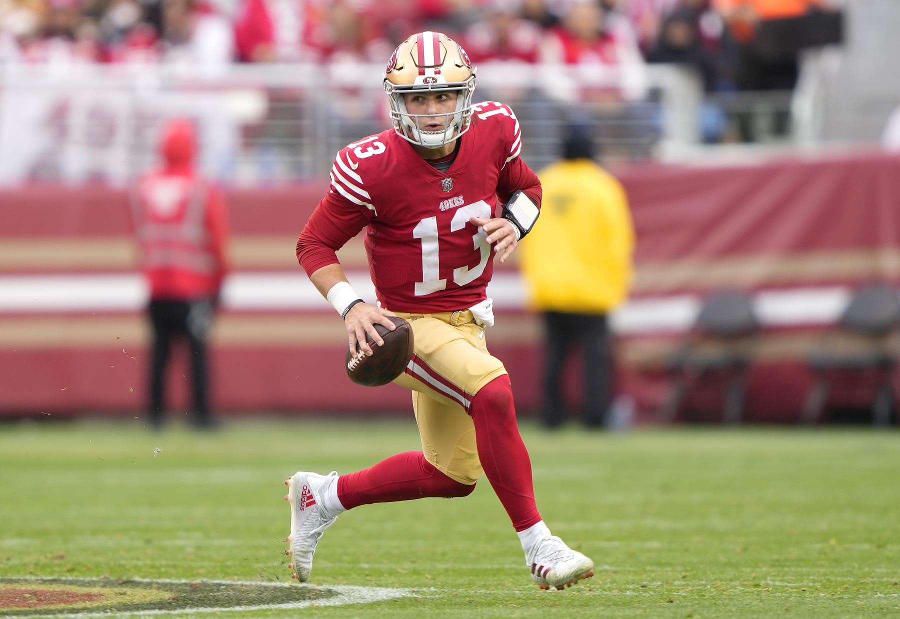 SANTA CLARA, CALIFORNIA - JANUARY 08: Brock Purdy #13 of the San Francisco 49ers looking to pass scrambles with the ball against the Arizona Cardinals during the third quarter of an NFL football game at Levi's Stadium on January 08, 2023 in Santa Clara, California. (Photo by Thearon W. Henderson/Getty Images)