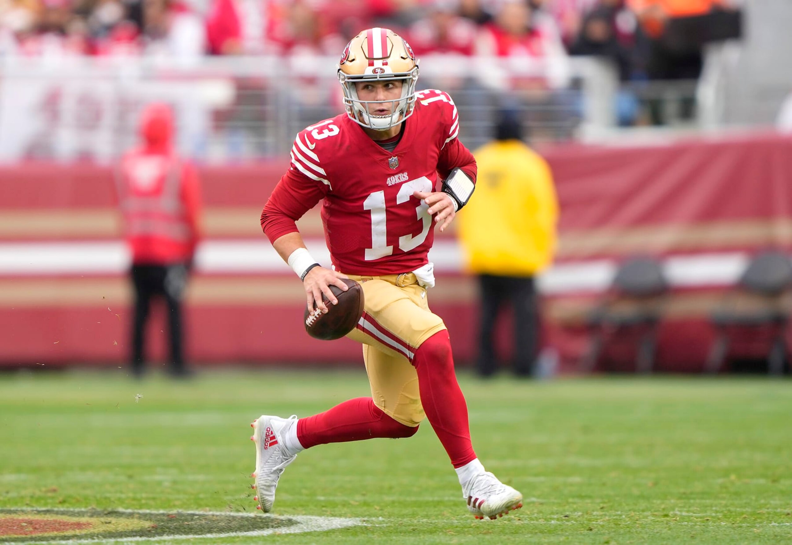 SANTA CLARA, CALIFORNIA - JANUARY 08: Brock Purdy #13 of the San Francisco 49ers looking to pass scrambles with the ball against the Arizona Cardinals during the third quarter of an NFL football game at Levi's Stadium on January 08, 2023 in Santa Clara, California. (Photo by Thearon W. Henderson/Getty Images)