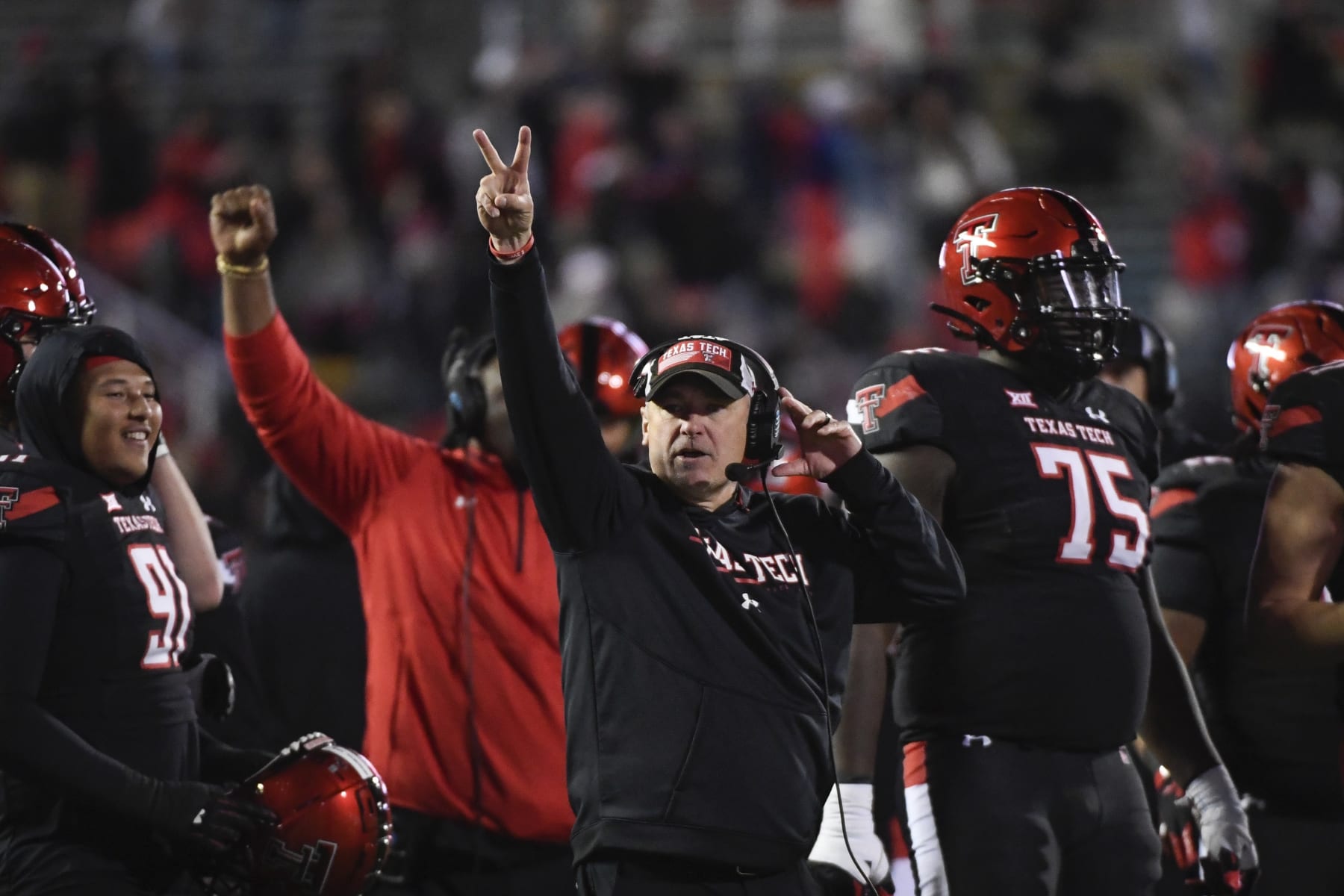 Texas Tech head coach Joey McGuire signals players against Kansas during the second half of an NCAA college football game Saturday, Nov. 12, 2022, in Lubbock, Texas. (AP Photo/Justin Rex)