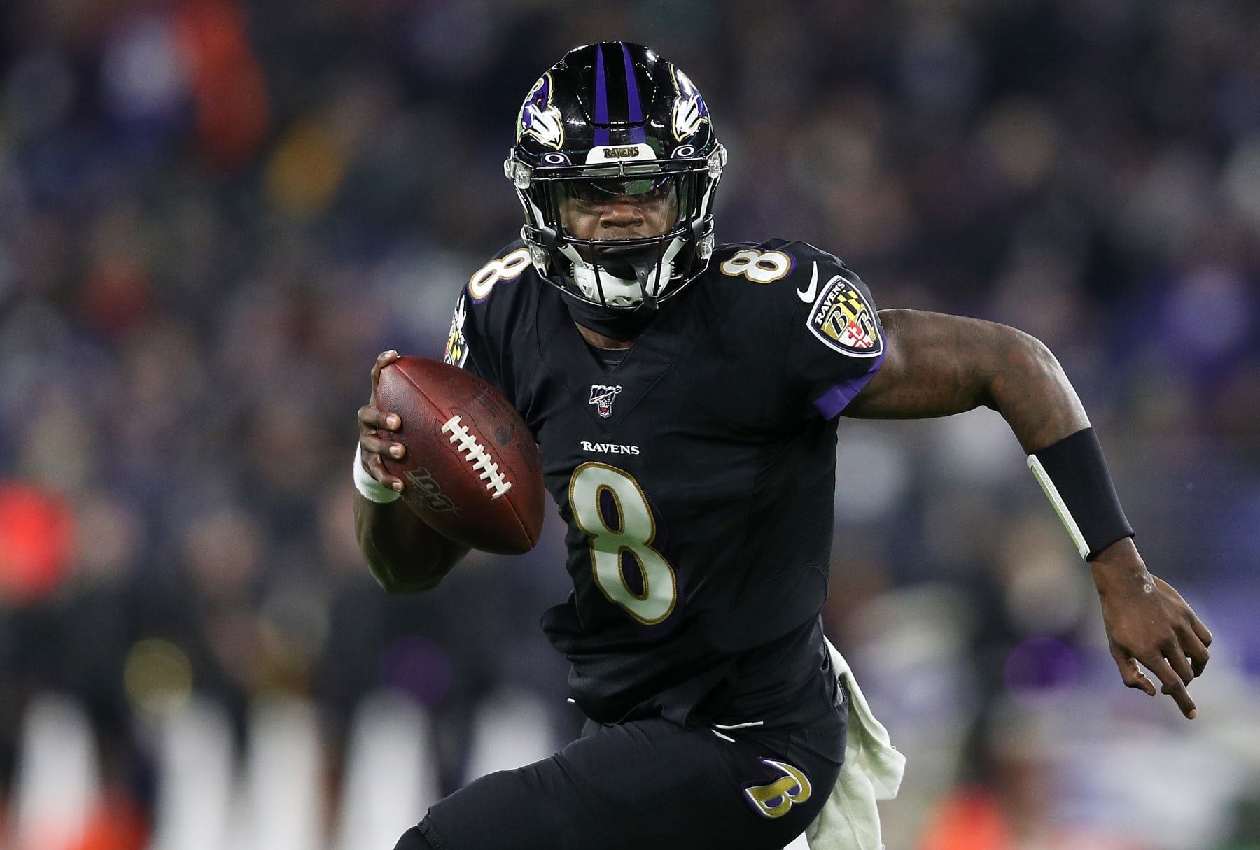 BALTIMORE, MARYLAND - DECEMBER 12: Quarterback Lamar Jackson #8 of the Baltimore Ravens breaks NFL single season record for rushing yards by a quarterback, formerly held by Michael Vick in the first quarter of the game against the New York Jets at M&T Bank Stadium on December 12, 2019 in Baltimore, Maryland. (Photo by Patrick Smith/Getty Images)