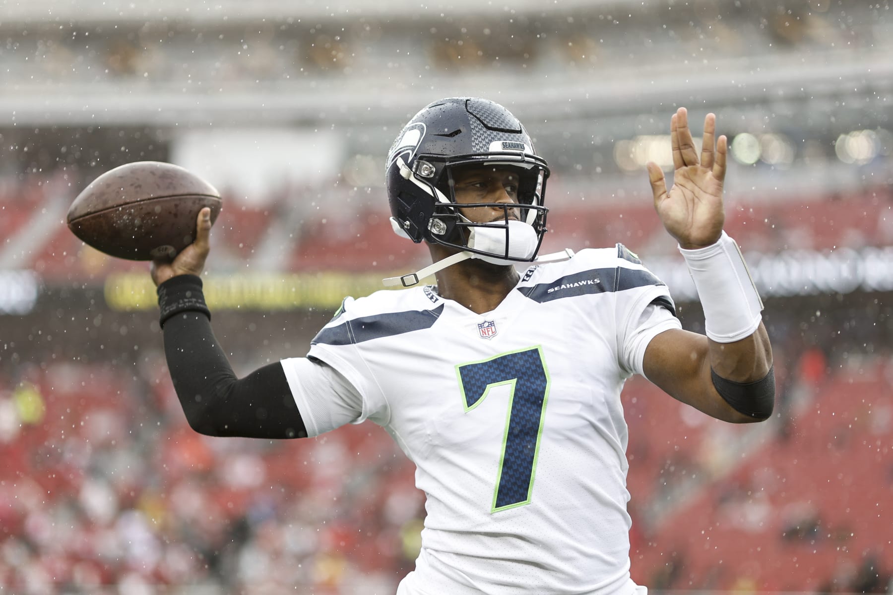SANTA CLARA, CALIFORNIA - JANUARY 14: Geno Smith #7 of the Seattle Seahawks passes as he warms up prior to an NFL football game between the San Francisco 49ers and the Seattle Seahawks at Levi's Stadium on January 14, 2023 in Santa Clara, California. (Photo by Michael Owens/Getty Images)