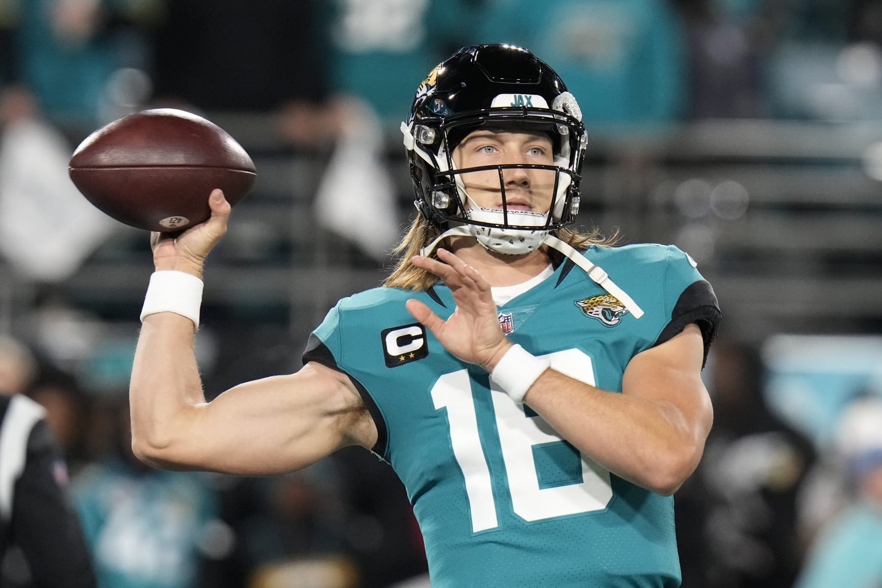 Jacksonville Jaguars quarterback Trevor Lawrence (16) warms up before an NFL wild-card football game between the Jacksonville Jaguars and the Los Angeles Chargers, Saturday, Jan. 14, 2023, in Jacksonville, Fla. (AP Photo/Chris O'Meara)