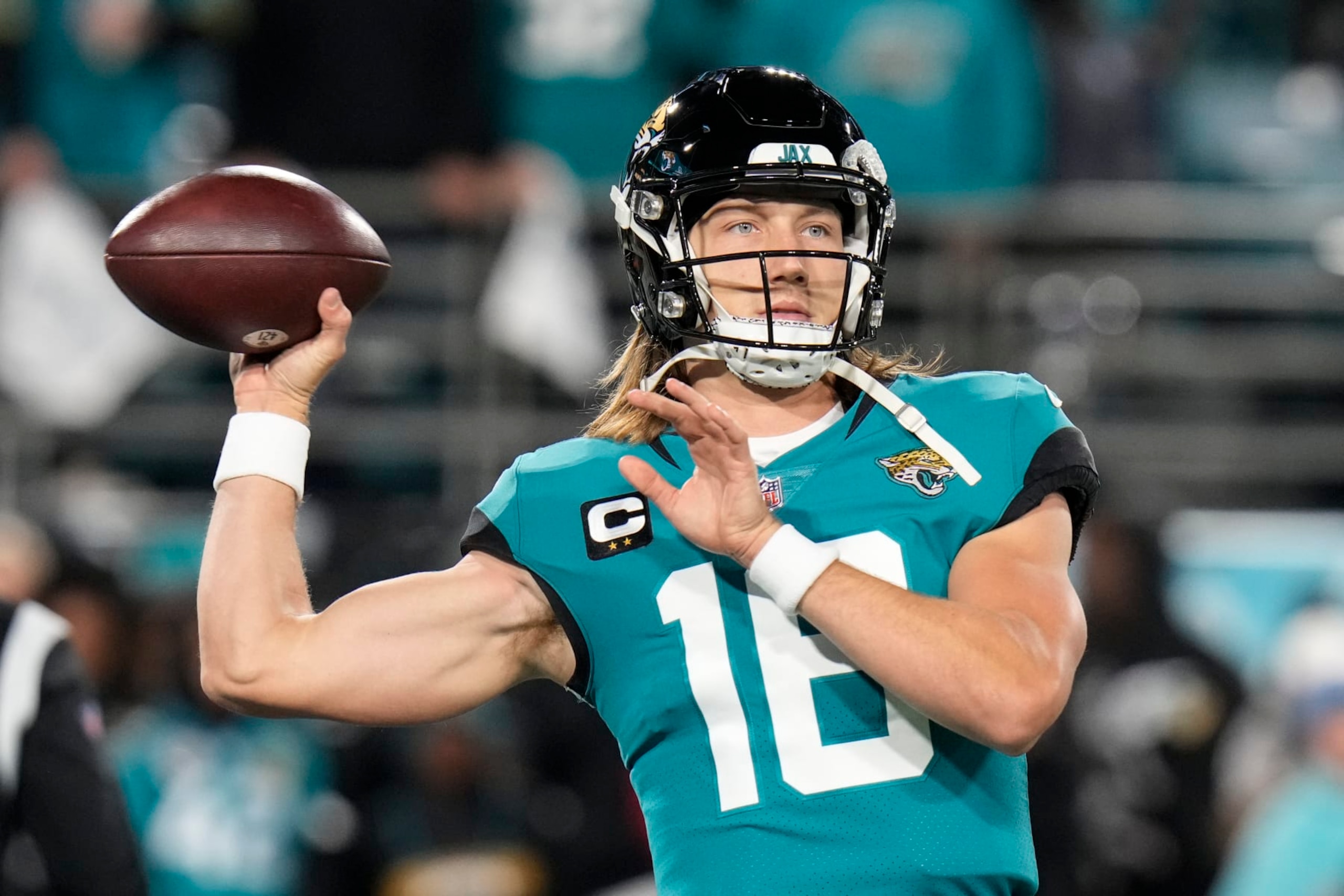 Jacksonville Jaguars quarterback Trevor Lawrence (16) warms up before an NFL wild-card football game between the Jacksonville Jaguars and the Los Angeles Chargers, Saturday, Jan. 14, 2023, in Jacksonville, Fla. (AP Photo/Chris O'Meara)