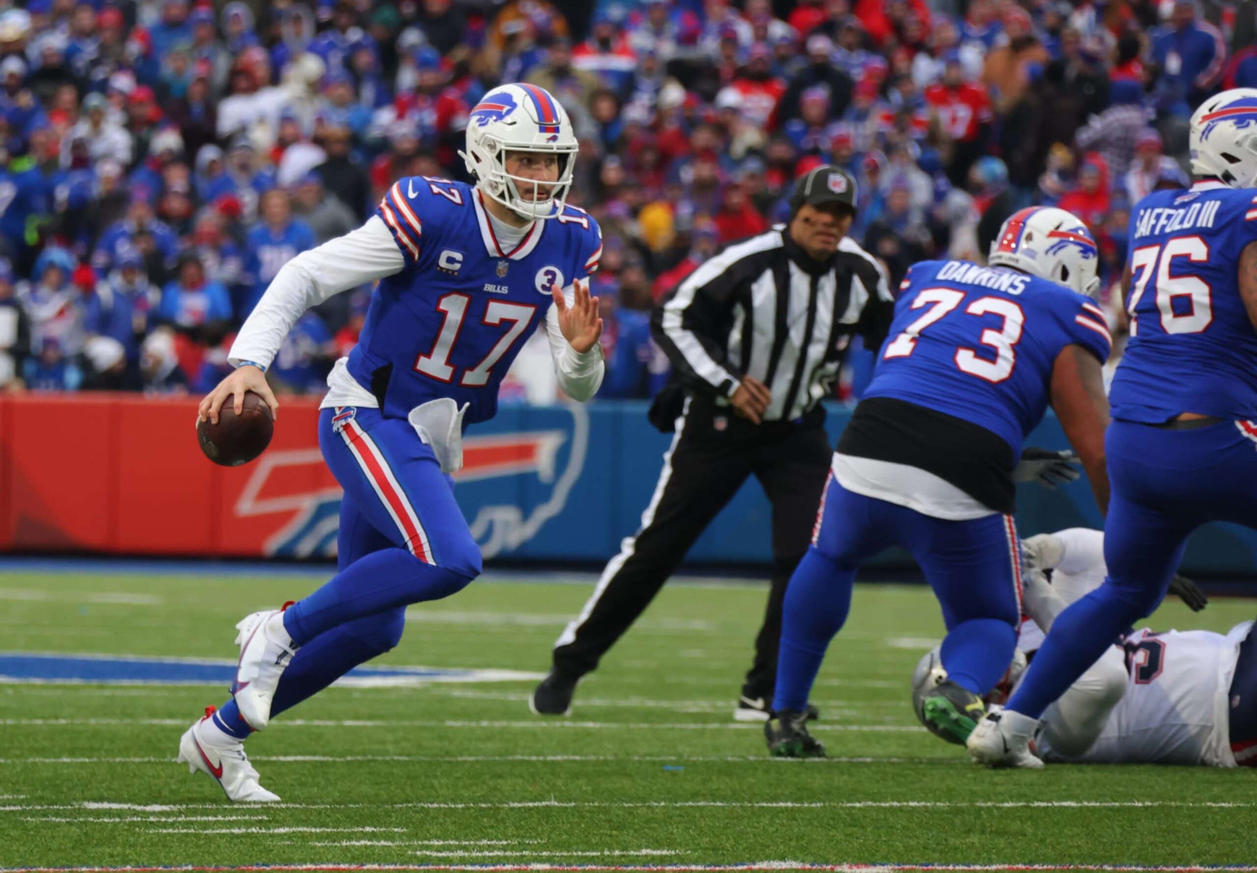 ORCHARD PARK, NY - JANUARY 08: Josh Allen #17 of the Buffalo Bills runs the ball against the New England Patriots at Highmark Stadium on January 8, 2023 in Orchard Park, New York. (Photo by Timothy T Ludwig/Getty Images)