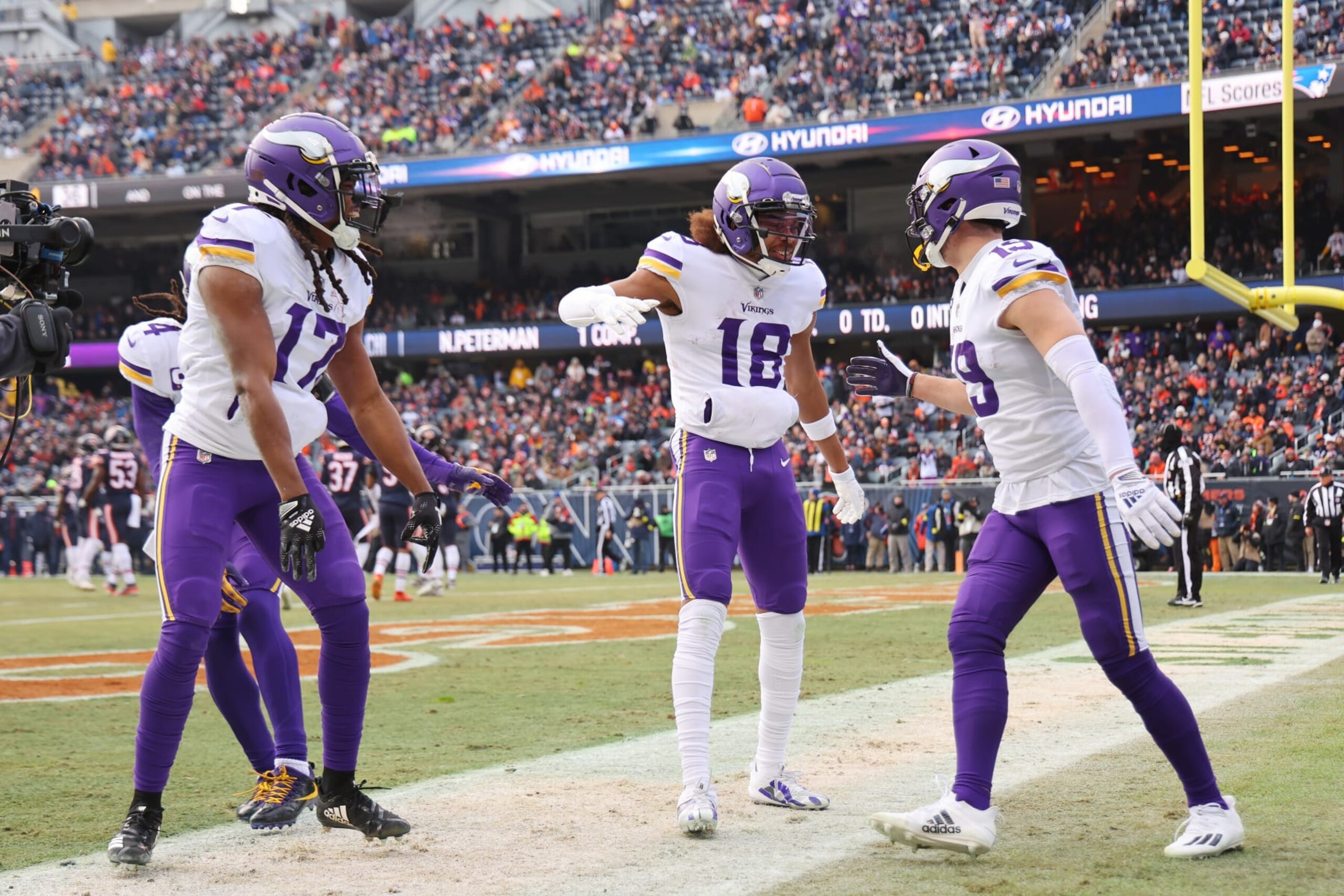 CHICAGO, ILLINOIS - JANUARY 08:  Wide receiver Adam Thielen #19 celebrates a touchdown with wide receiver K.J. Osborn #17 and wide receiver Justin Jefferson #18 of the Minnesota Vikings during the 1st quarter of the game against the Chicago Bears at Soldier Field on January 08, 2023 in Chicago, Illinois. (Photo by Michael Reaves/Getty Images)