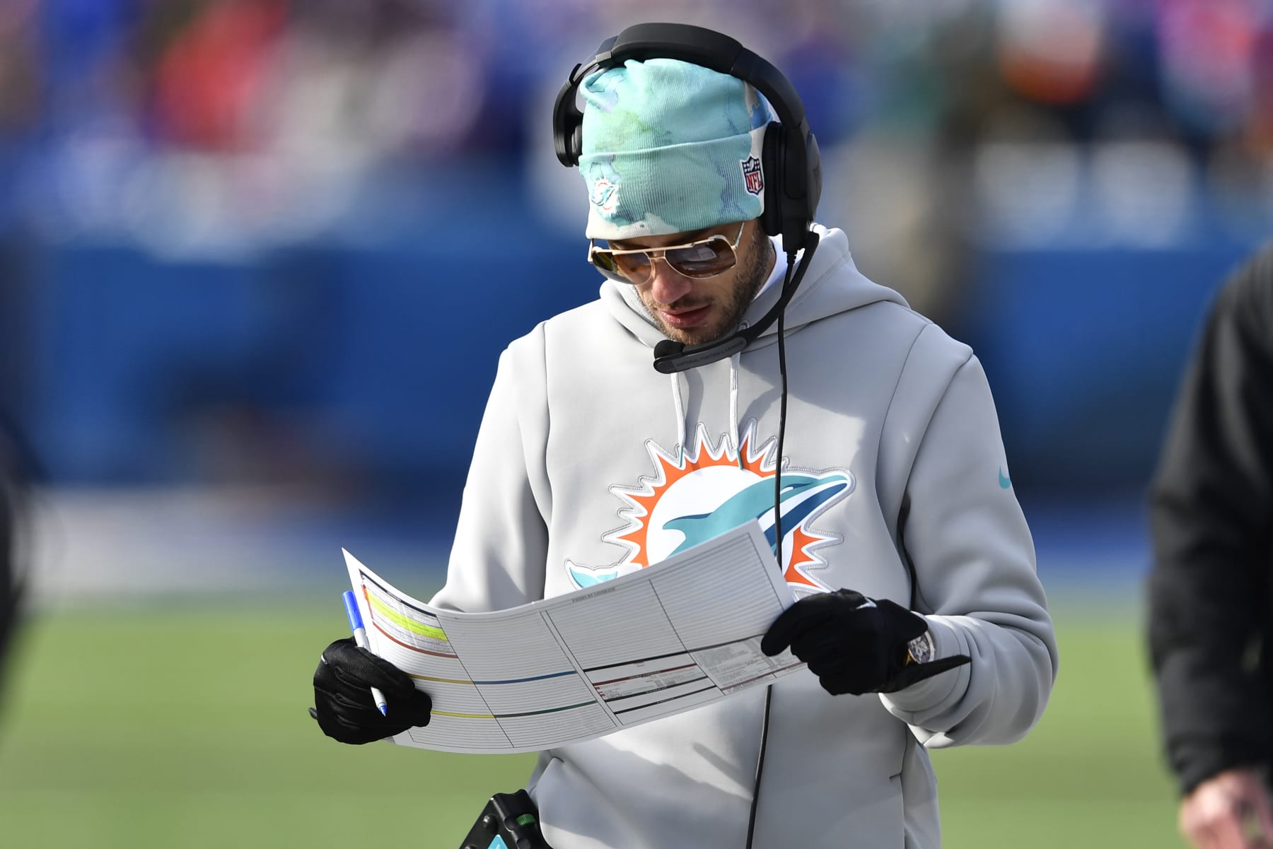 Miami Dolphins head coach Mike McDaniel looks at his play sheet during the first half of an NFL wild-card playoff football game against the Buffalo Bills, Sunday, Jan. 15, 2023, in Orchard Park, N.Y. (AP Photo/Adrian Kraus)