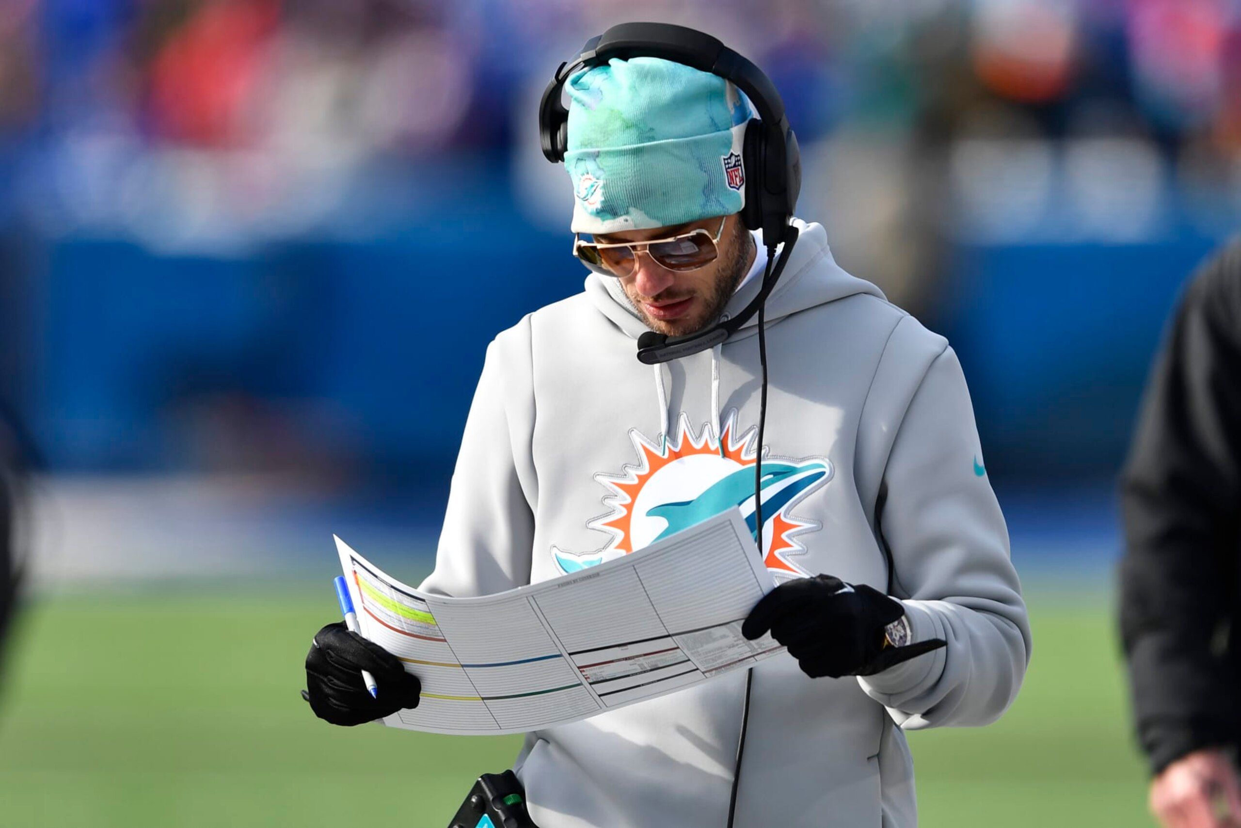 Miami Dolphins head coach Mike McDaniel looks at his play sheet during the first half of an NFL wild-card playoff football game against the Buffalo Bills, Sunday, Jan. 15, 2023, in Orchard Park, N.Y. (AP Photo/Adrian Kraus)