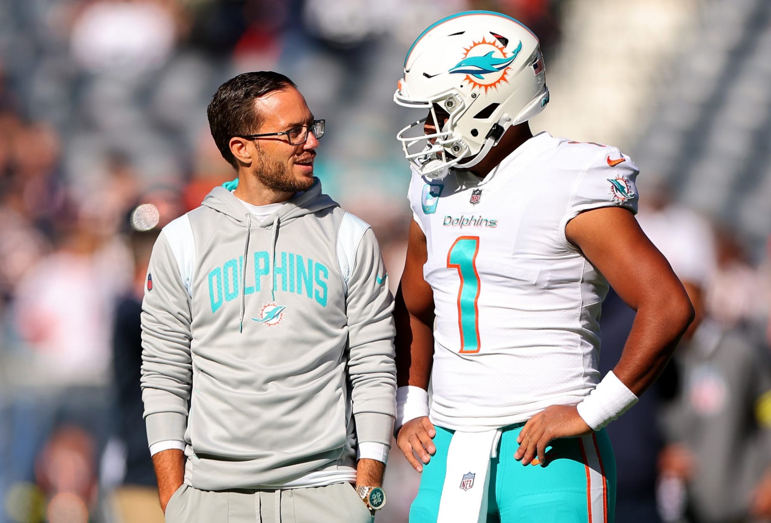 CHICAGO, ILLINOIS - NOVEMBER 06: Head coach Mike McDaniel of the Miami Dolphins speaks with Tua Tagovailoa #1 prior to the game against the Chicago Bears at Soldier Field on November 06, 2022 in Chicago, Illinois. (Photo by Michael Reaves/Getty Images)