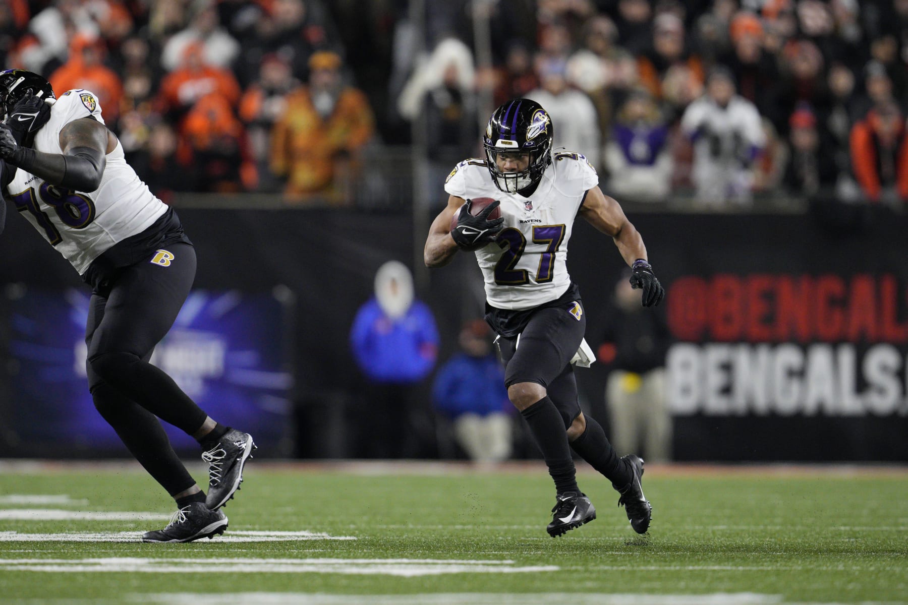 Baltimore Ravens running back J.K. Dobbins runs with the ball in the first half of an NFL wild-card playoff football game against the Cincinnati Bengals in Cincinnati, Sunday, Jan. 15, 2023. (AP Photo/Jeff Dean)